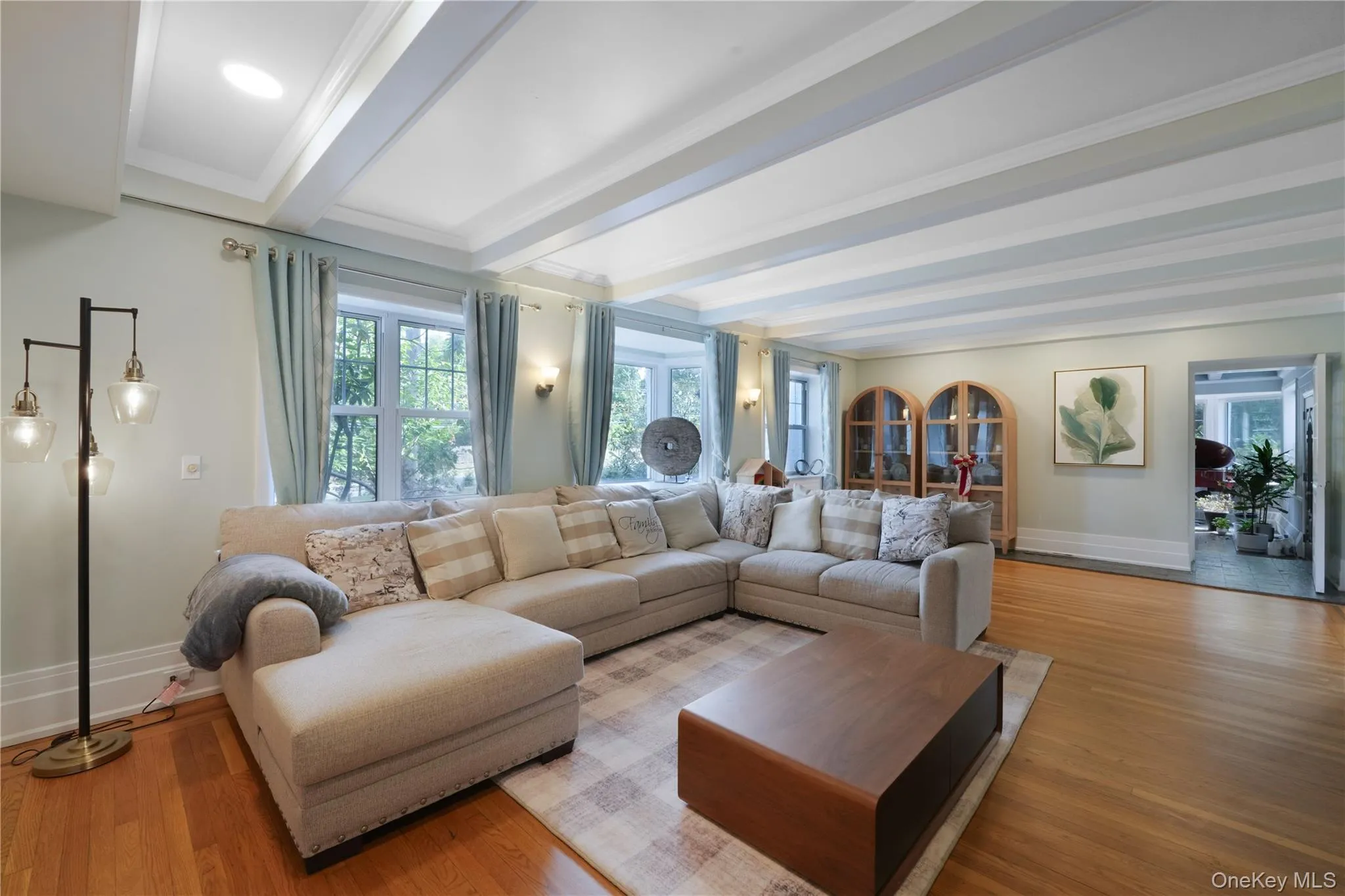 Living area with beamed ceiling and wood finished floors Living area with beamed ceiling and wood finished floors