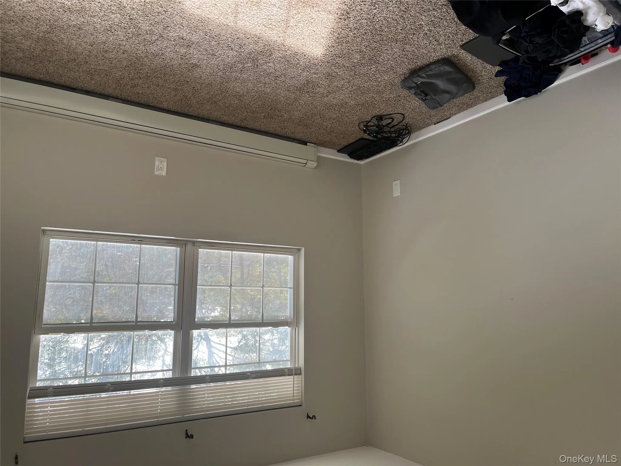 Unfurnished room with baseboard heating and carpet flooring Unfurnished room with baseboard heating and carpet flooring