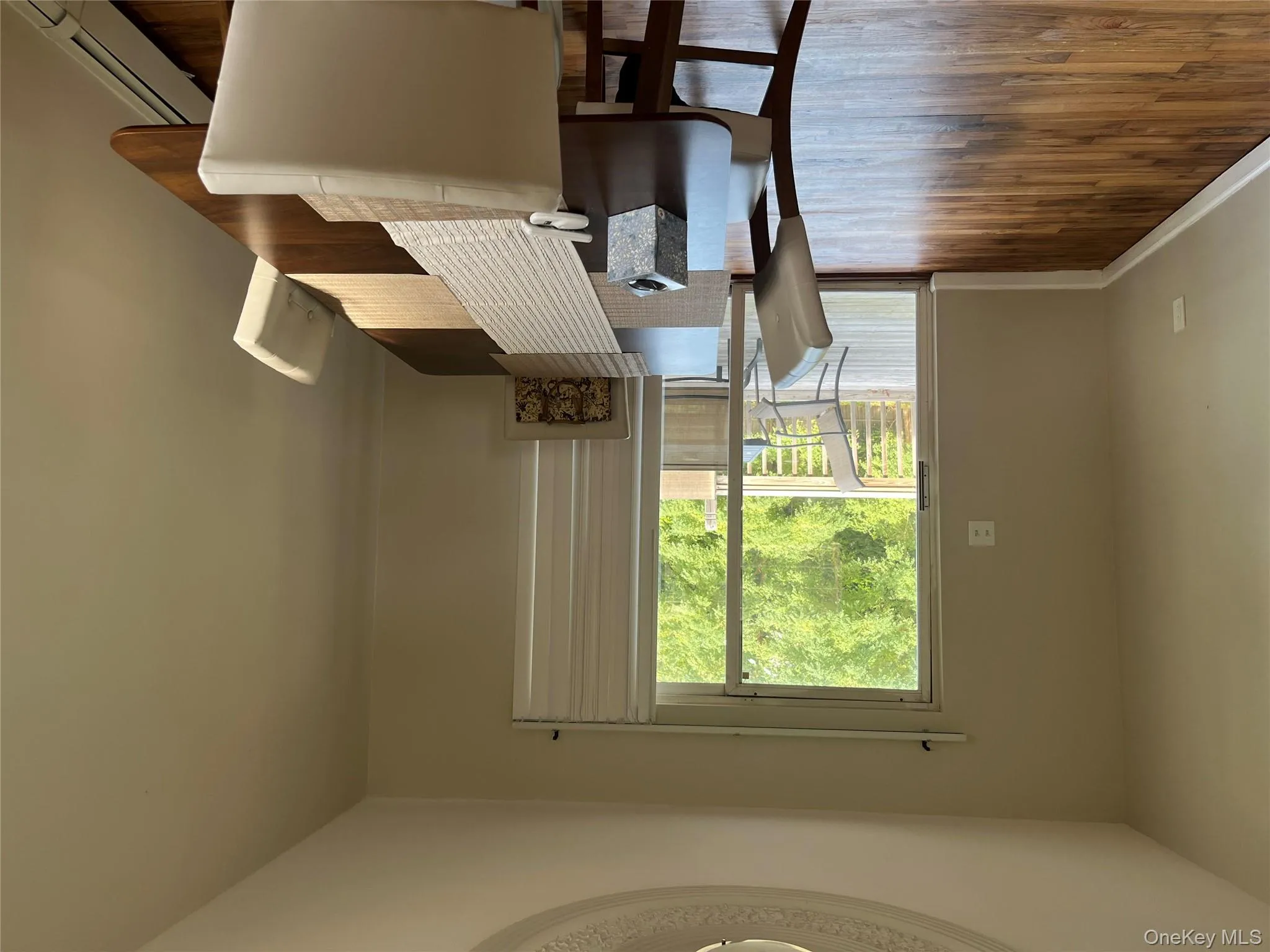 Dining area featuring a baseboard heating unit and dark wood-type flooring Dining area featuring a baseboard heating unit and dark wood-type flooring