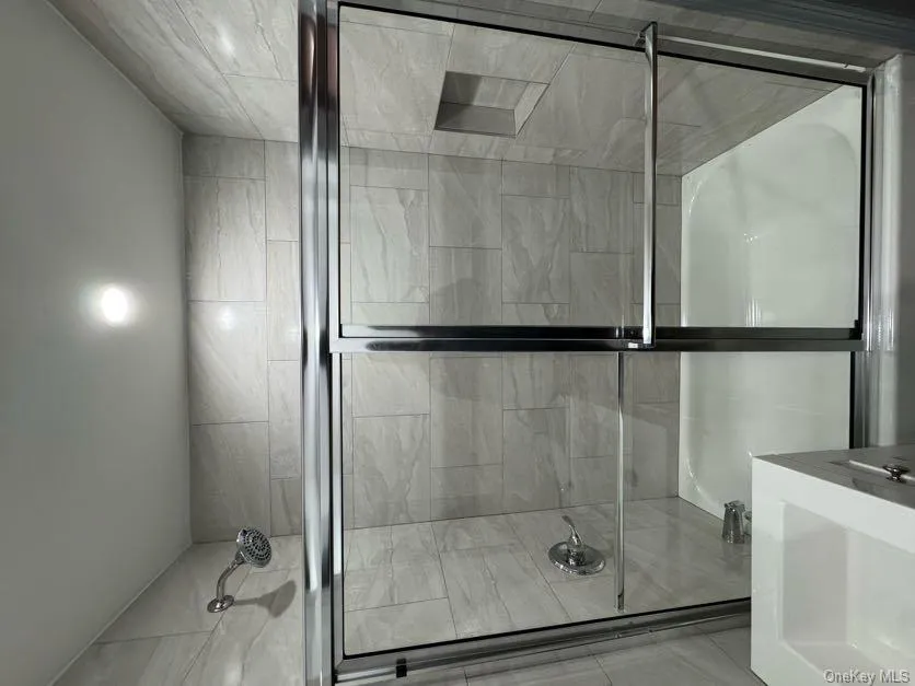 Full bath featuring vanity and bath / shower combo with glass door Full bath featuring vanity and bath / shower combo with glass door