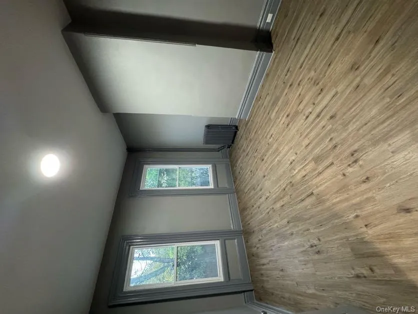 Unfurnished room featuring light wood-type flooring and radiator heating unit Unfurnished room featuring light wood-type flooring and radiator heating unit