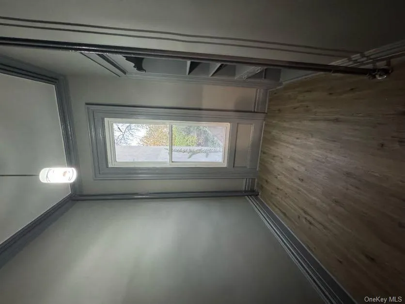 Doorway to outside featuring ornamental molding and wood finished floors Doorway to outside featuring ornamental molding and wood finished floors