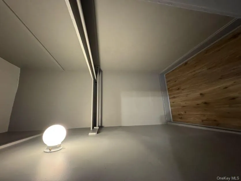 Walk in closet with dark wood finished floors Walk in closet with dark wood finished floors