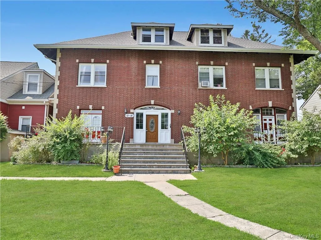 View of front of home featuring a front yard and brick siding View of front of home featuring a front yard and brick siding