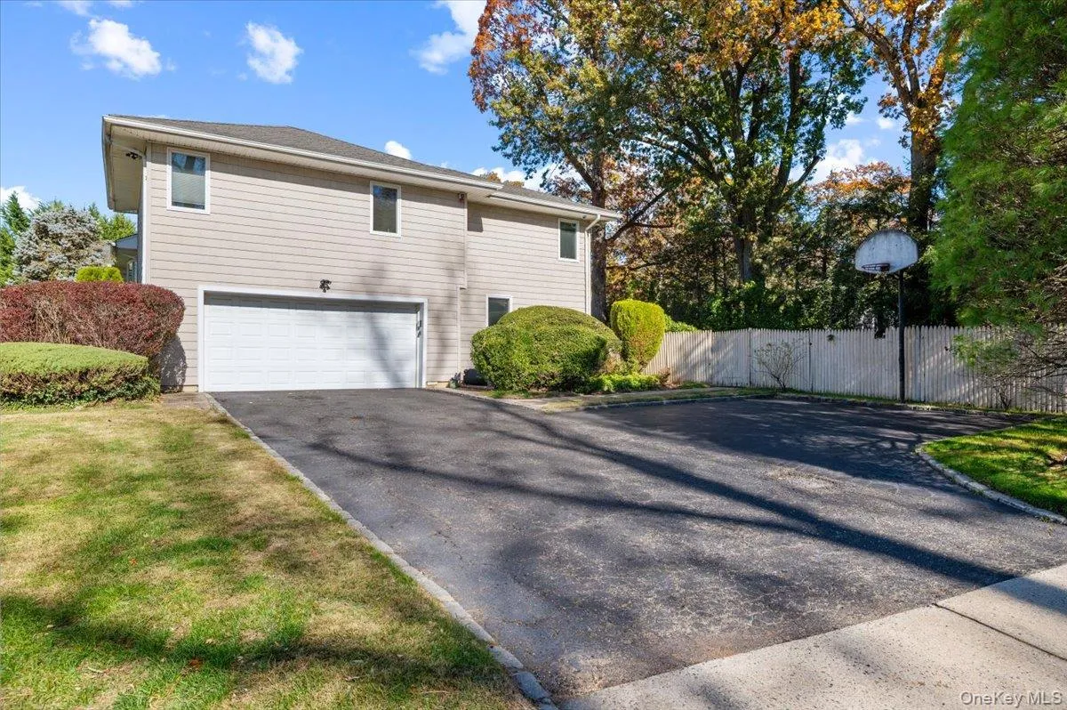 View of property exterior with asphalt driveway and an attached garage View of property exterior with asphalt driveway and an attached garage
