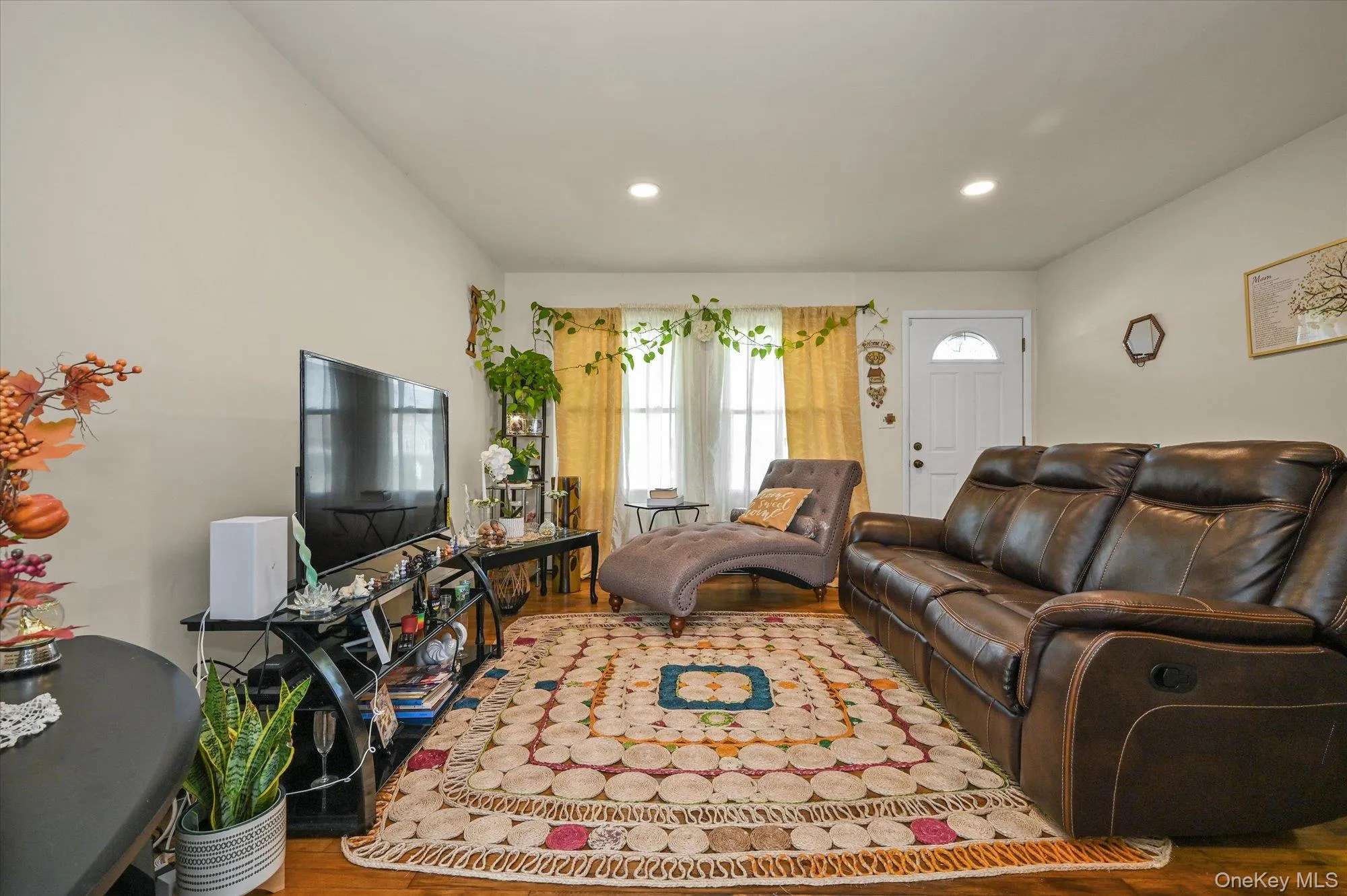 Living room featuring wood finished floors and recessed lighting Living room featuring wood finished floors and recessed lighting