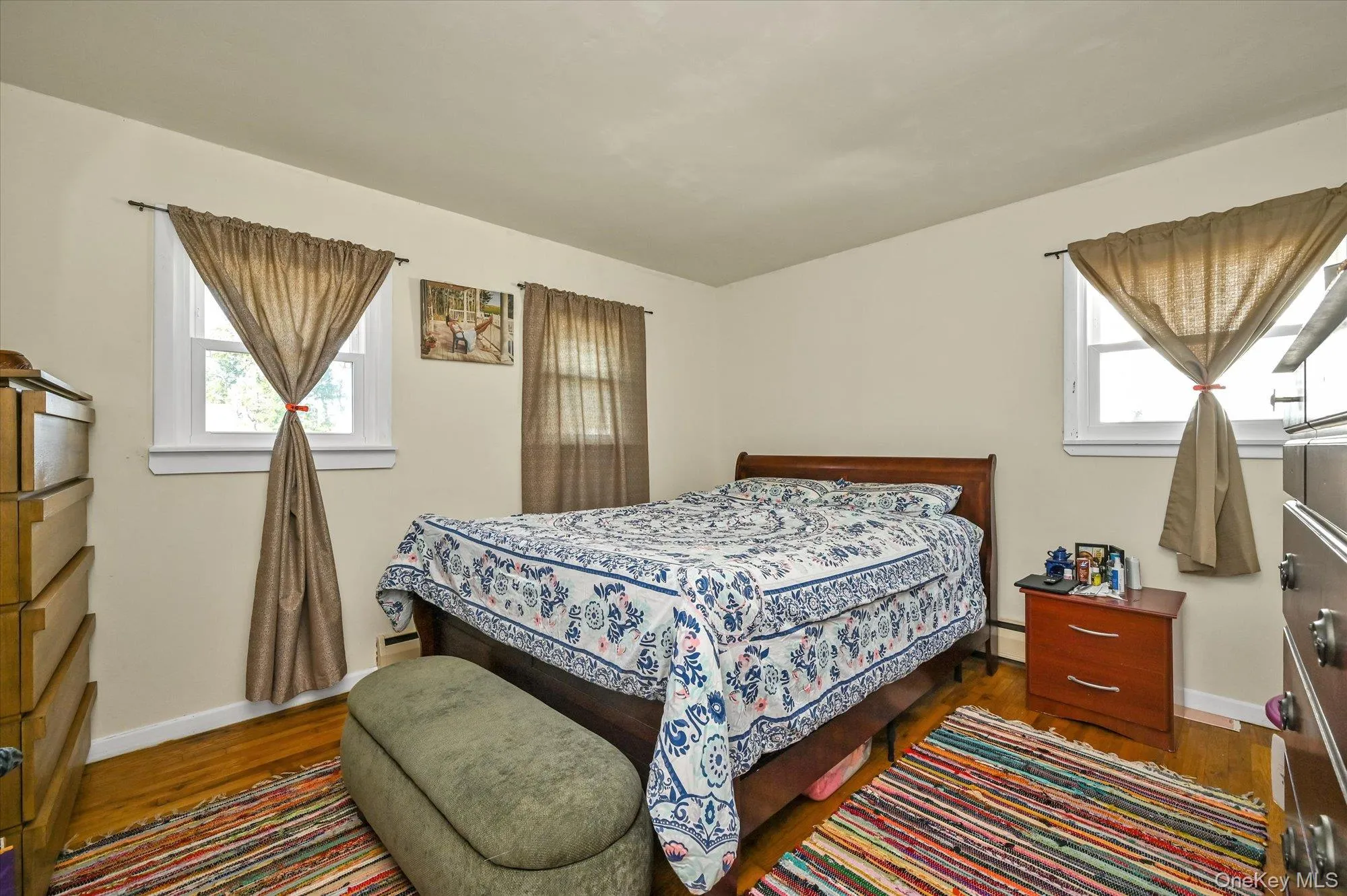 Bedroom with dark wood finished floors Bedroom with dark wood finished floors