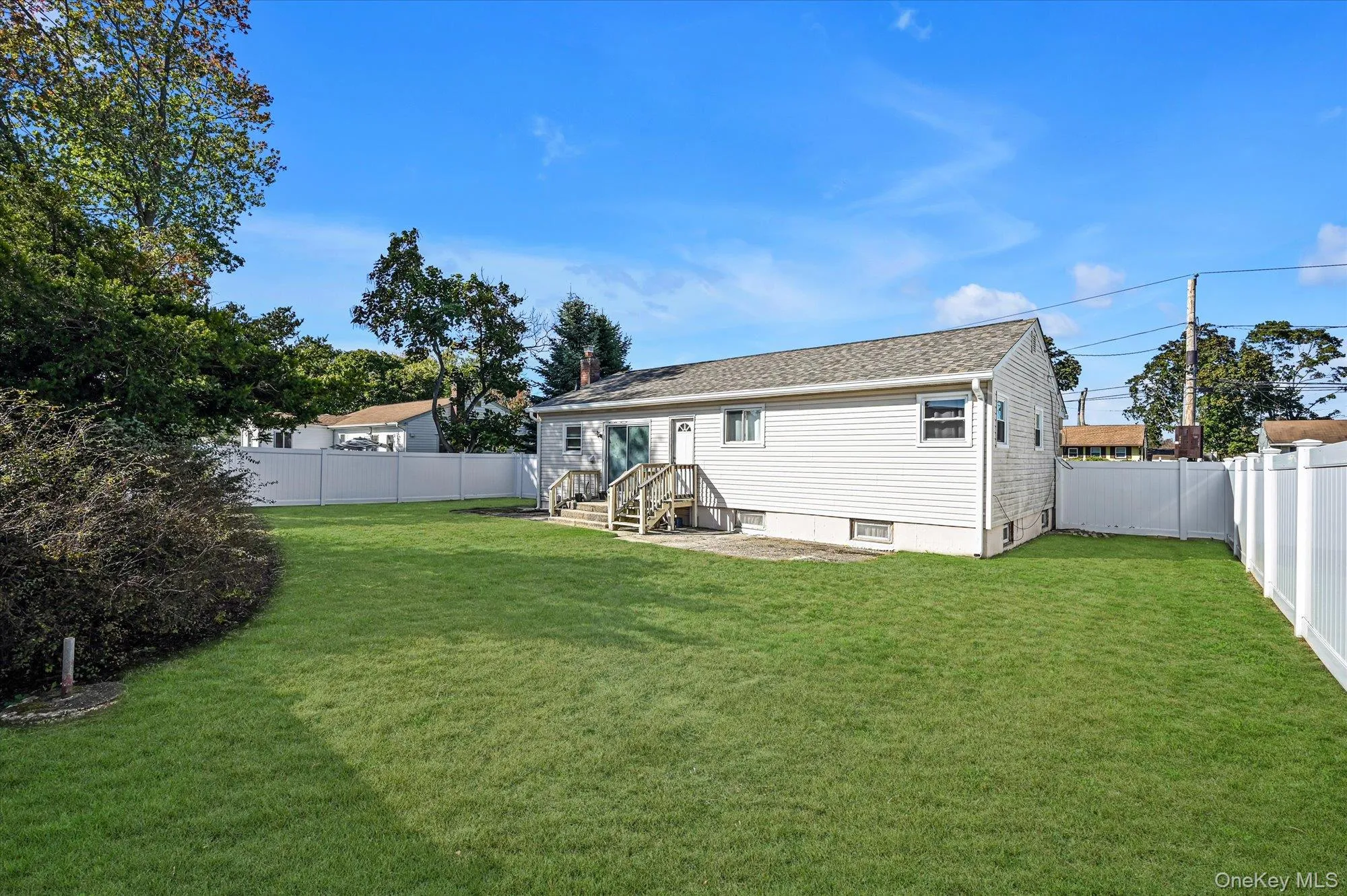 Back of property with a fenced backyard and a patio area Back of property with a fenced backyard and a patio area