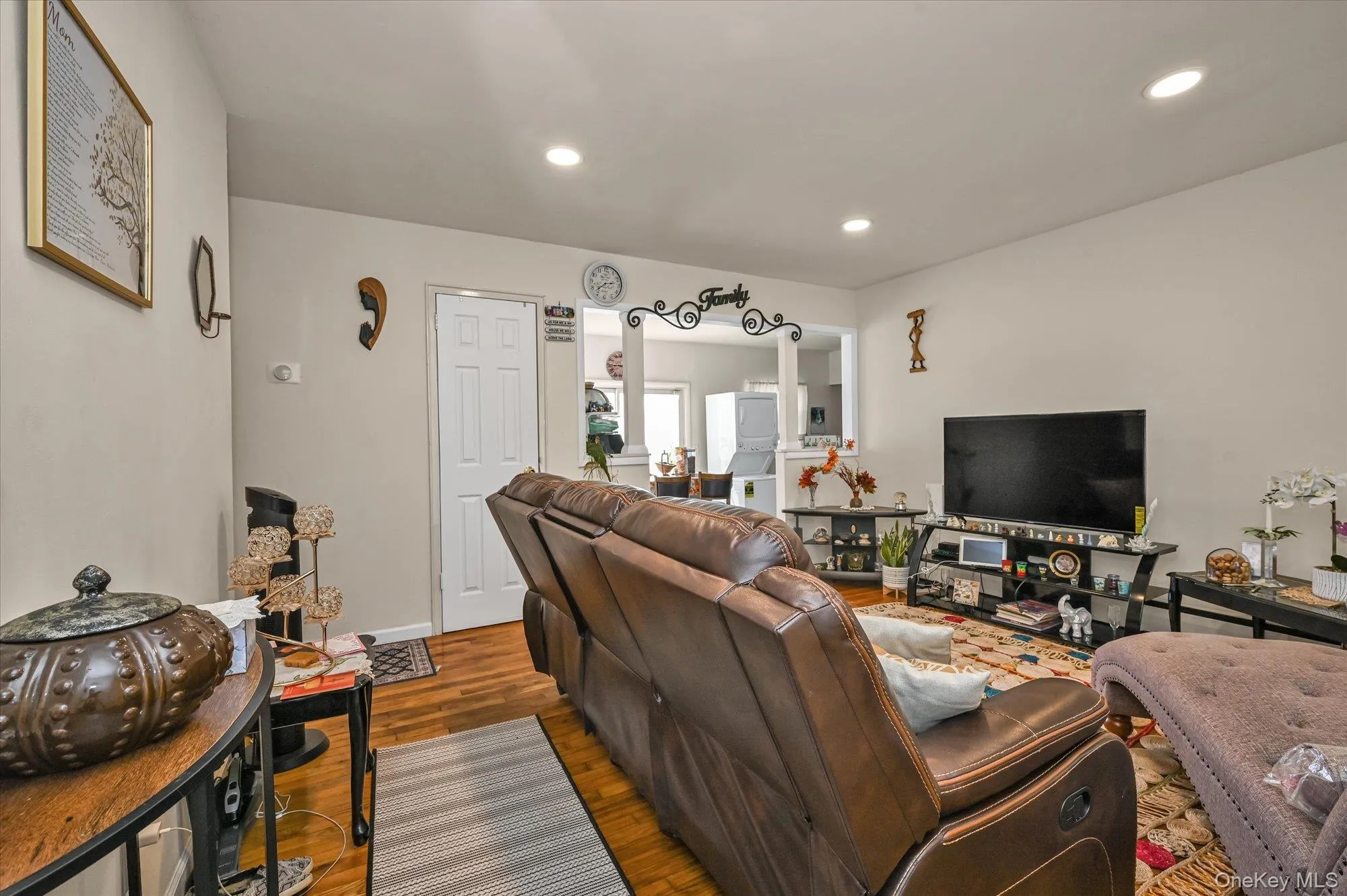 Living area featuring wood finished floors and recessed lighting Living area featuring wood finished floors and recessed lighting