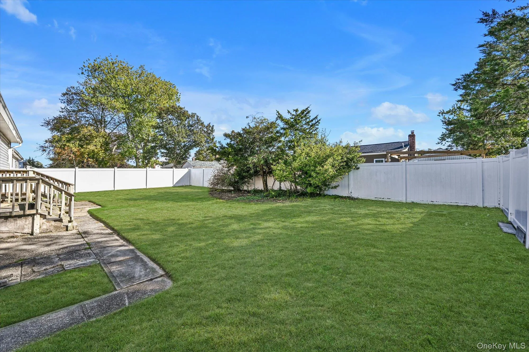 Fenced backyard with a patio area Fenced backyard with a patio area
