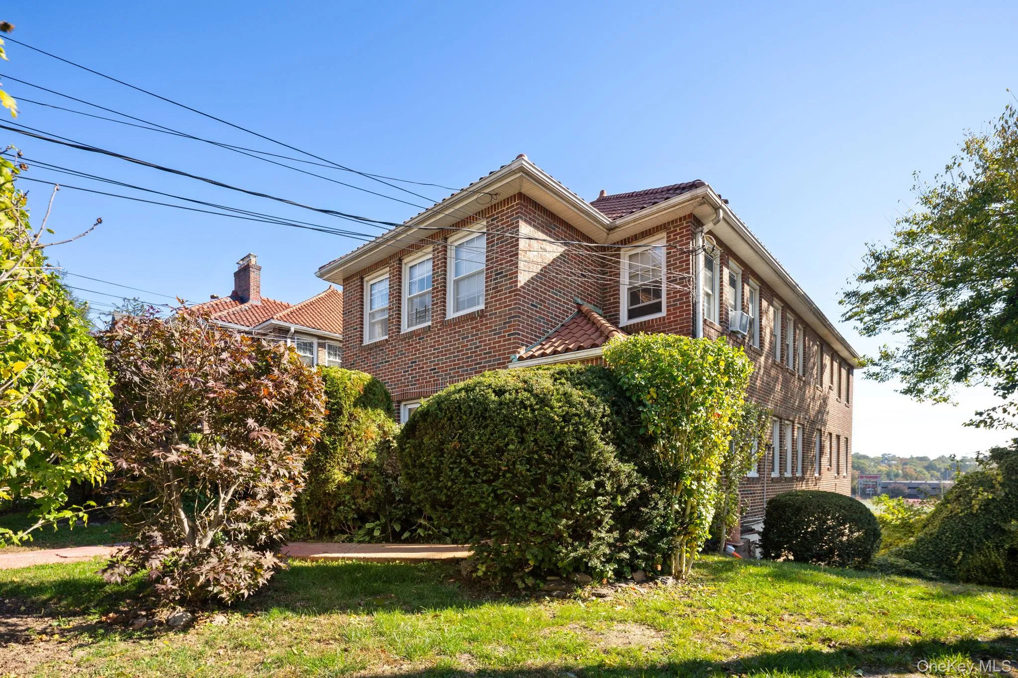 View of side of home featuring brick siding and a yard View of side of home featuring brick siding and a yard
