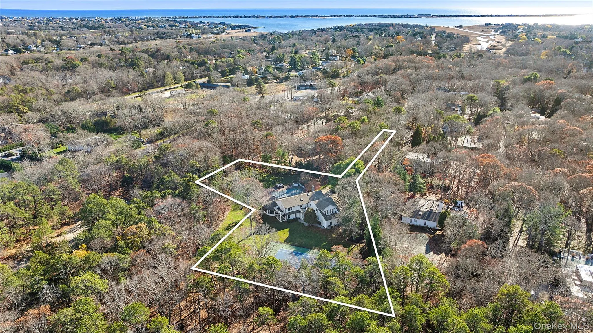 Aerial view of property's location featuring a nearby body of water and property boundaries highlighted
