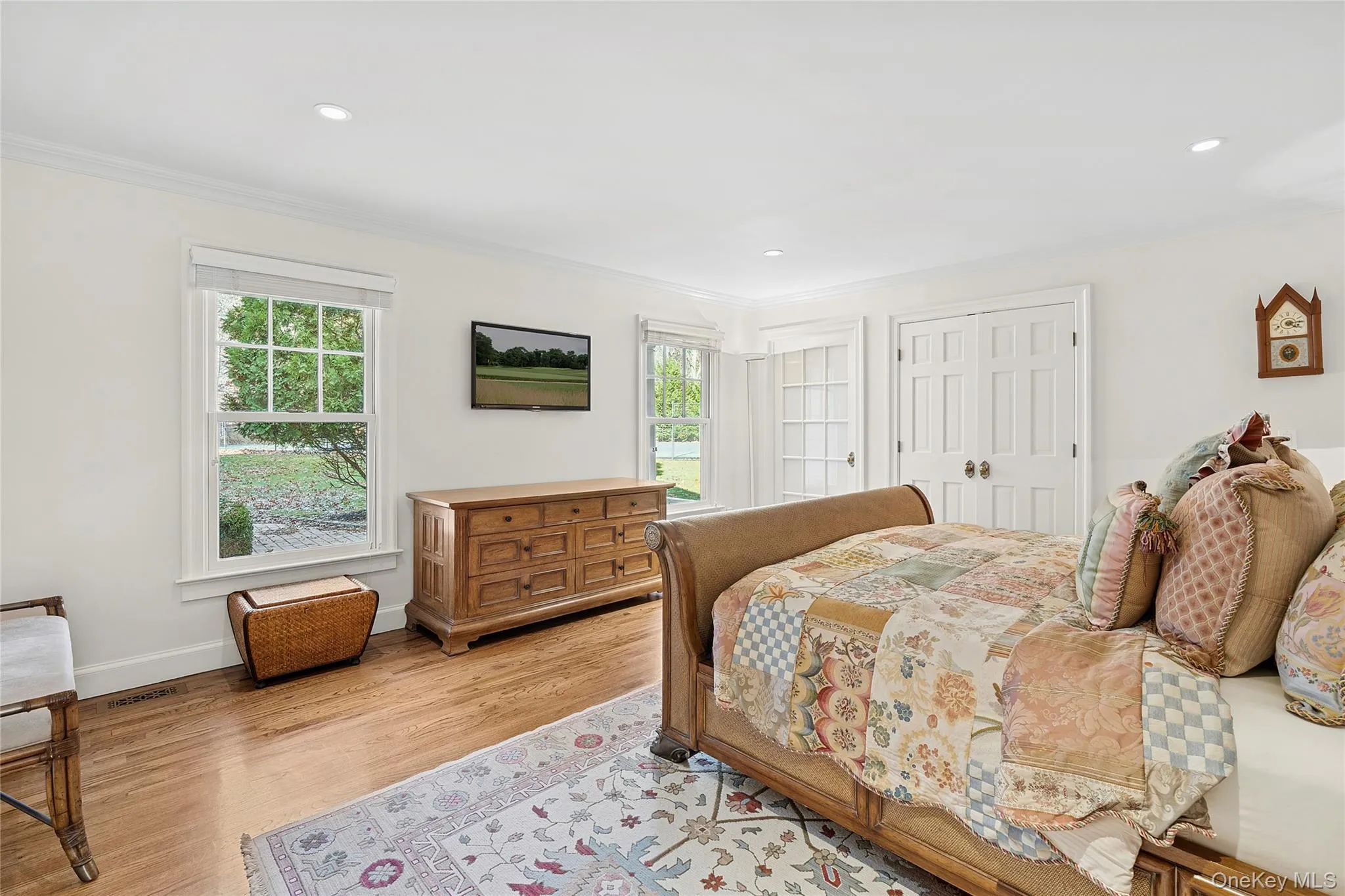 Bedroom featuring a closet, crown molding, and wood finished floors