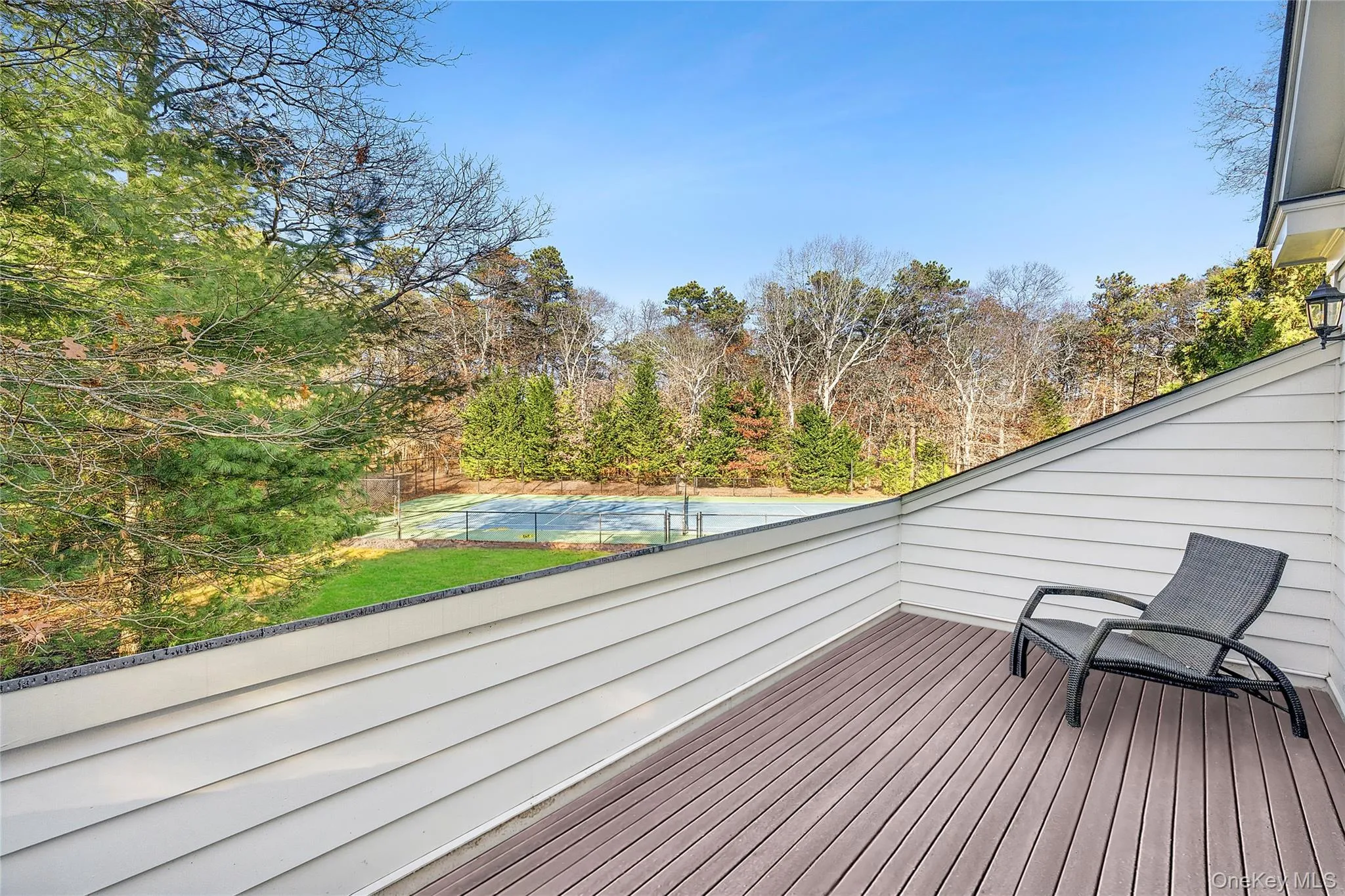 Deck featuring view of scattered trees