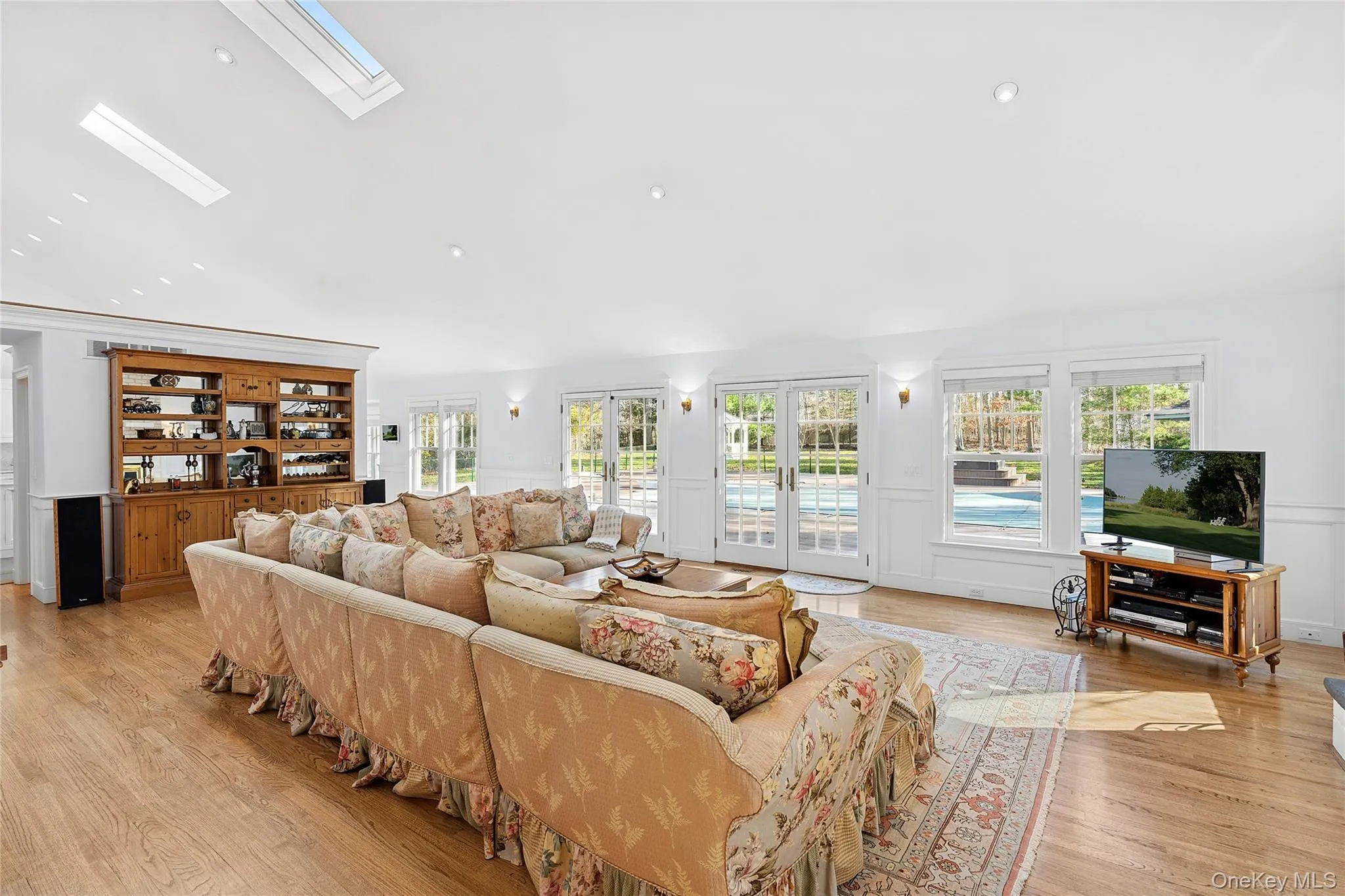 Living area featuring a skylight and light wood-style flooring