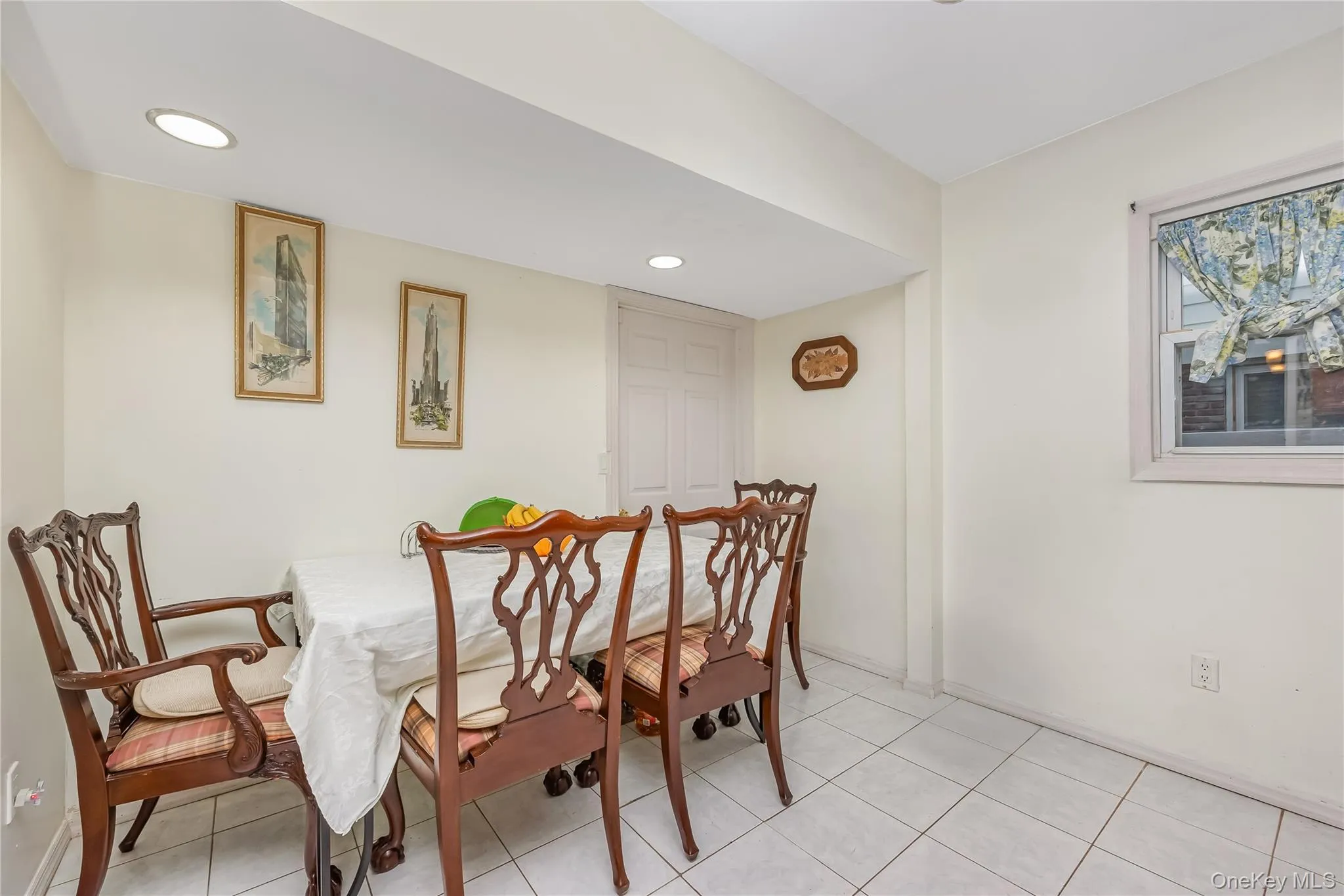 Dining area with recessed lighting and light tile patterned flooring Dining area with recessed lighting and light tile patterned flooring