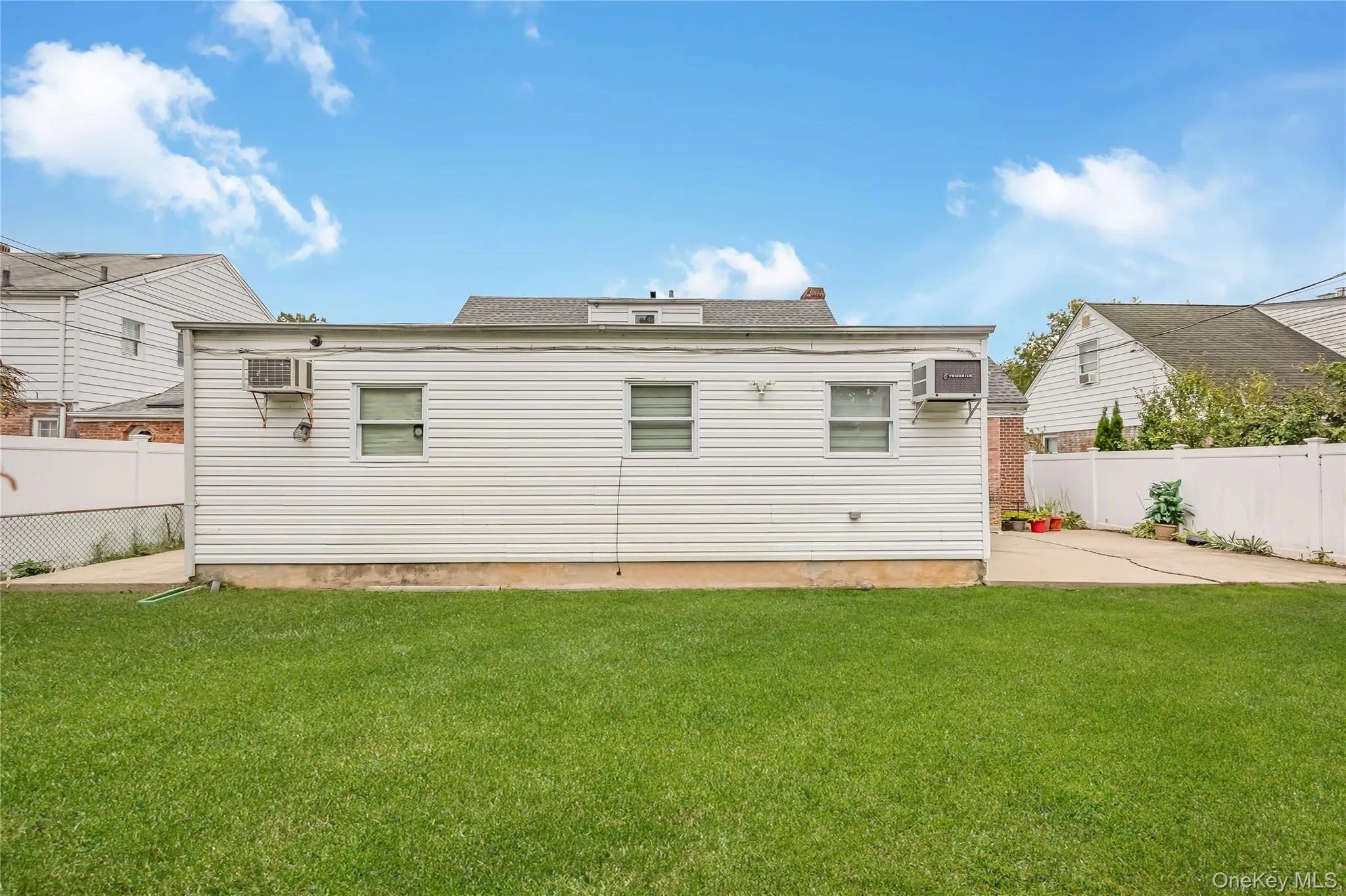 Rear view of house featuring an AC wall unit Rear view of house featuring an AC wall unit