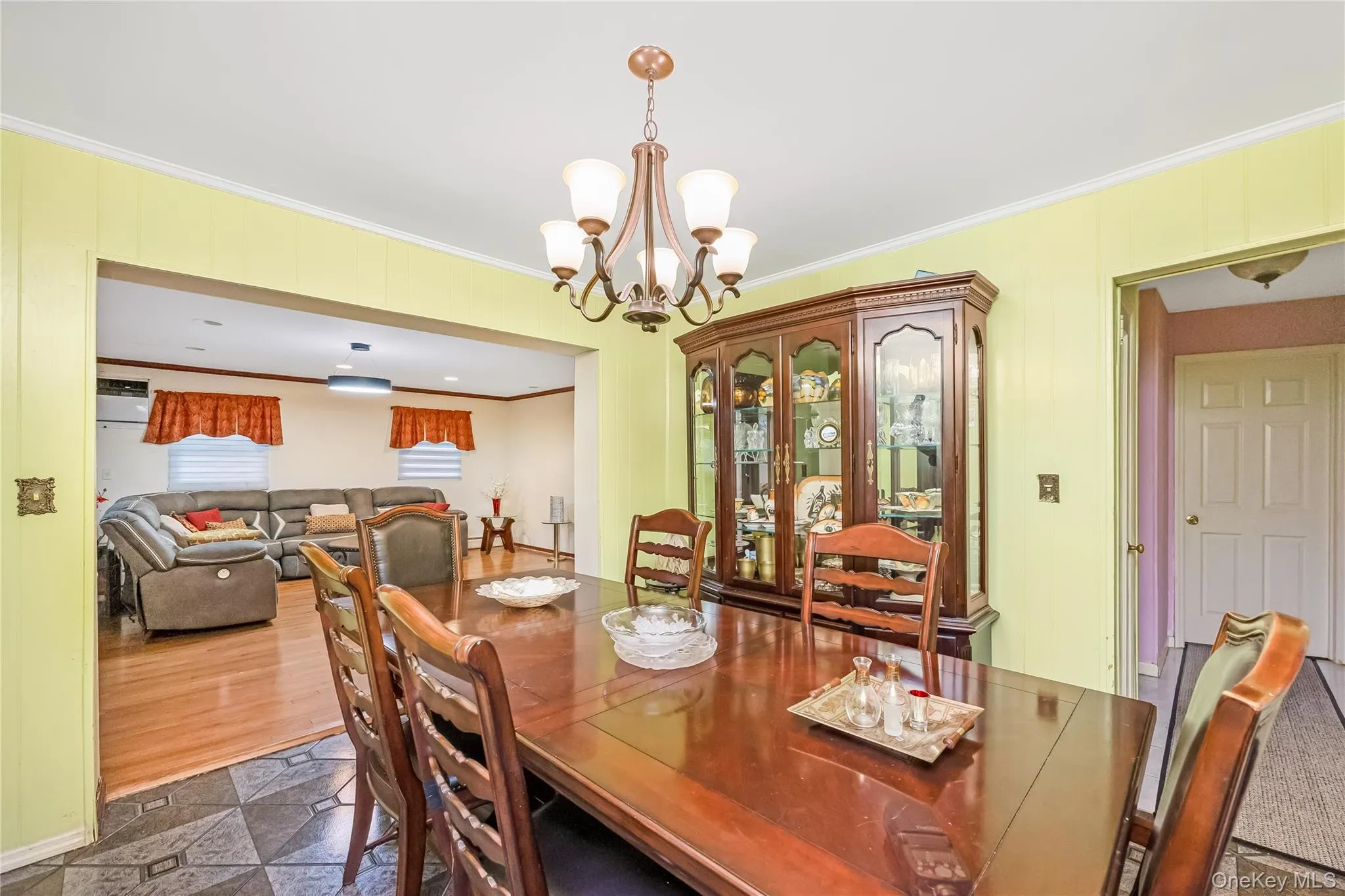 Dining area with ornamental molding and a chandelier Dining area with ornamental molding and a chandelier