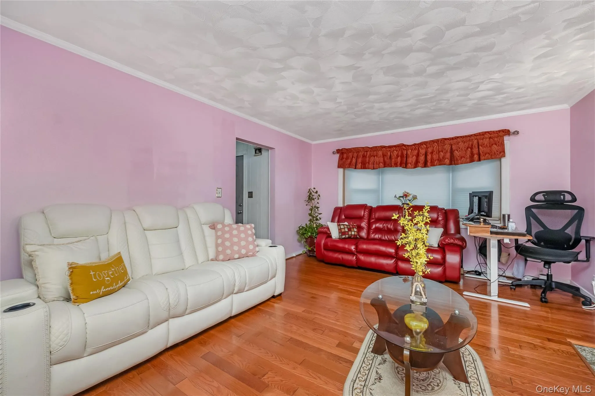 Living room featuring wood finished floors, ornamental molding, and a desk Living room featuring wood finished floors, ornamental molding, and a desk
