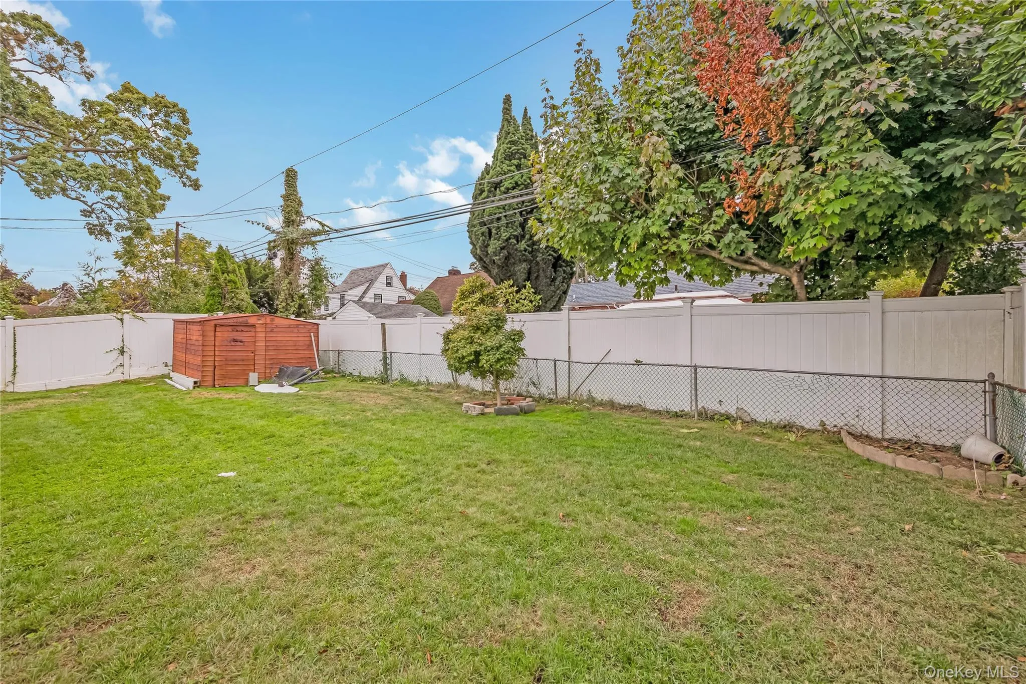 Fenced backyard with a storage shed Fenced backyard with a storage shed