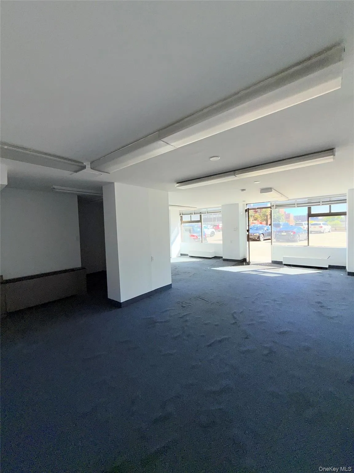 Spare room featuring dark carpet Spare room featuring dark carpet