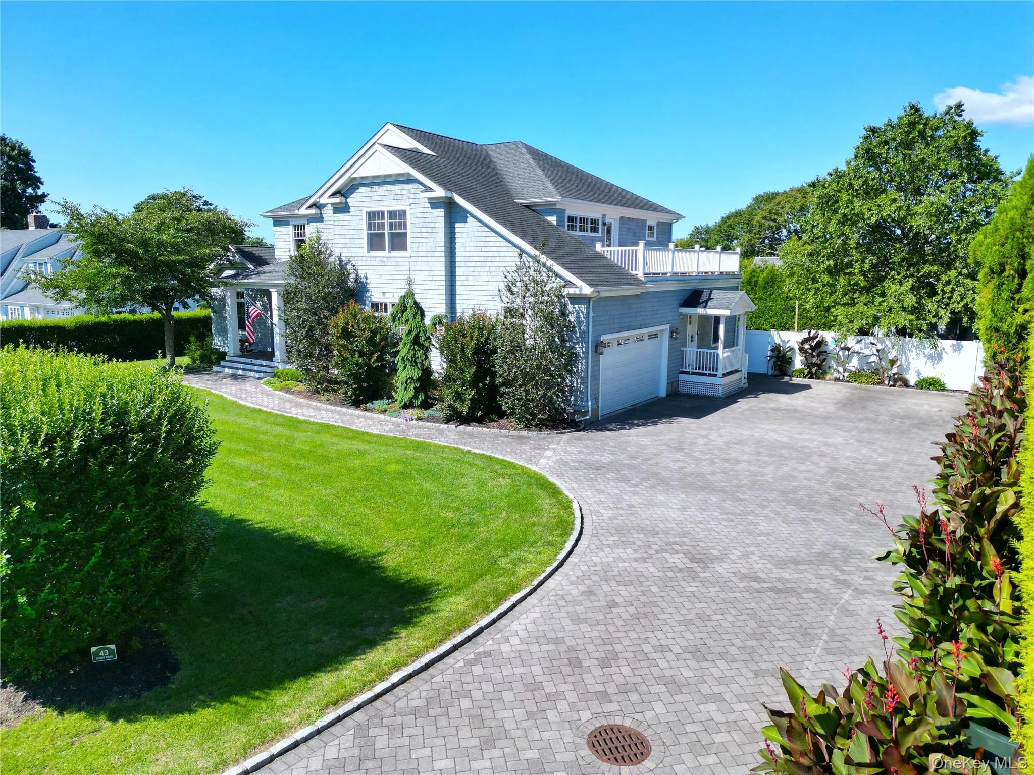 View of property exterior with decorative driveway, a lawn, a garage, and roof with shingles View of property exterior with decorative driveway, a lawn, a garage, and roof with shingles