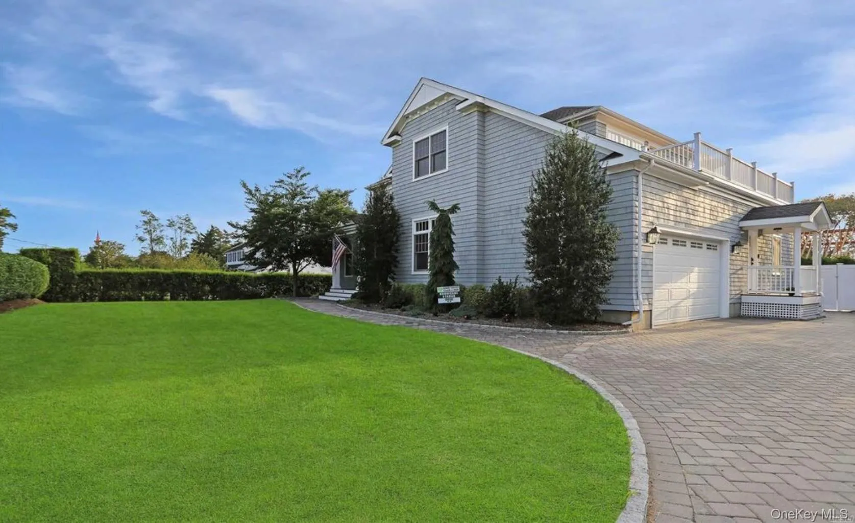 View of side of home featuring decorative driveway and an attached garage View of side of home featuring decorative driveway and an attached garage