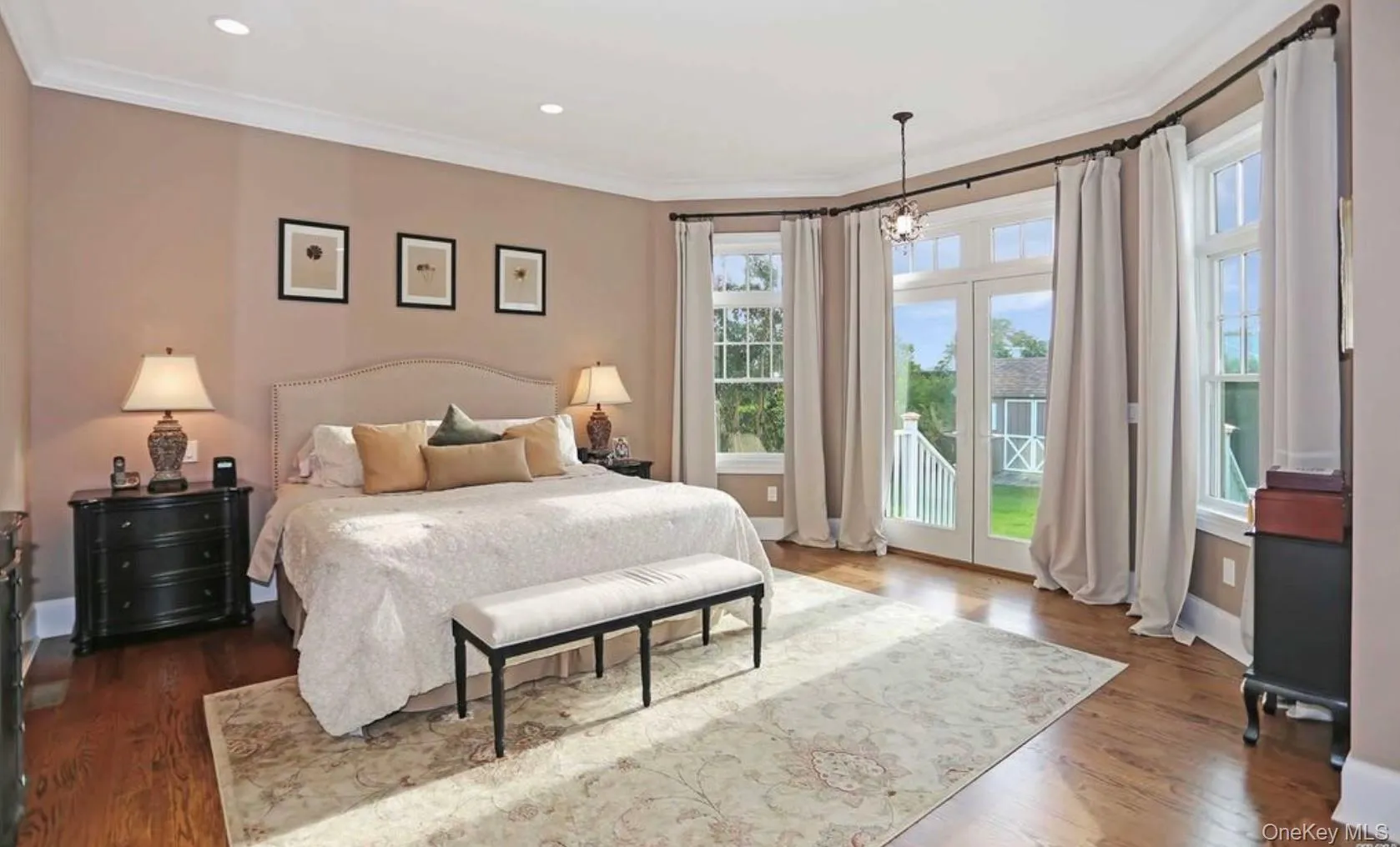 Bedroom with ornamental molding, access to exterior, dark wood-style flooring, recessed lighting, and a chandelier Bedroom with ornamental molding, access to exterior, dark wood-style flooring, recessed lighting, and a chandelier