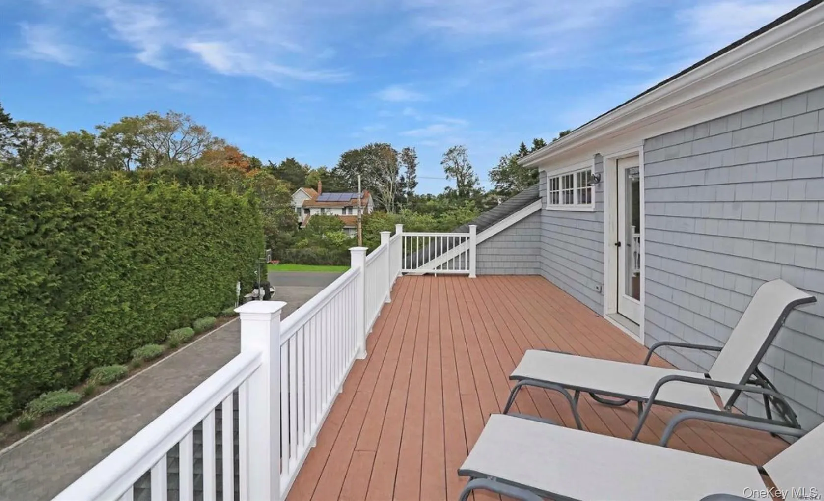 Wooden deck featuring view of scattered trees Wooden deck featuring view of scattered trees