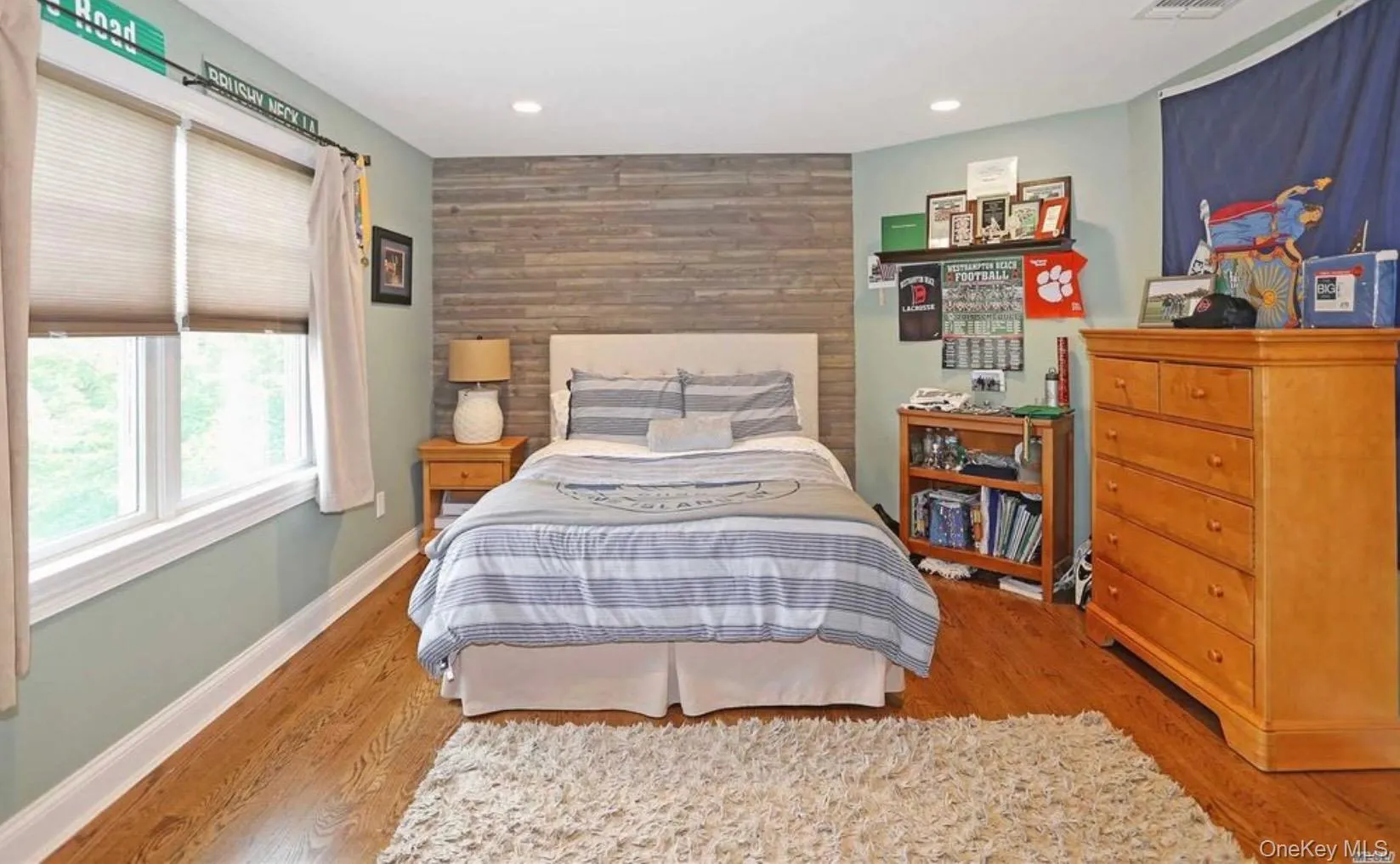 Bedroom featuring an accent wall, light wood-style flooring, wood walls, and recessed lighting Bedroom featuring an accent wall, light wood-style flooring, wood walls, and recessed lighting