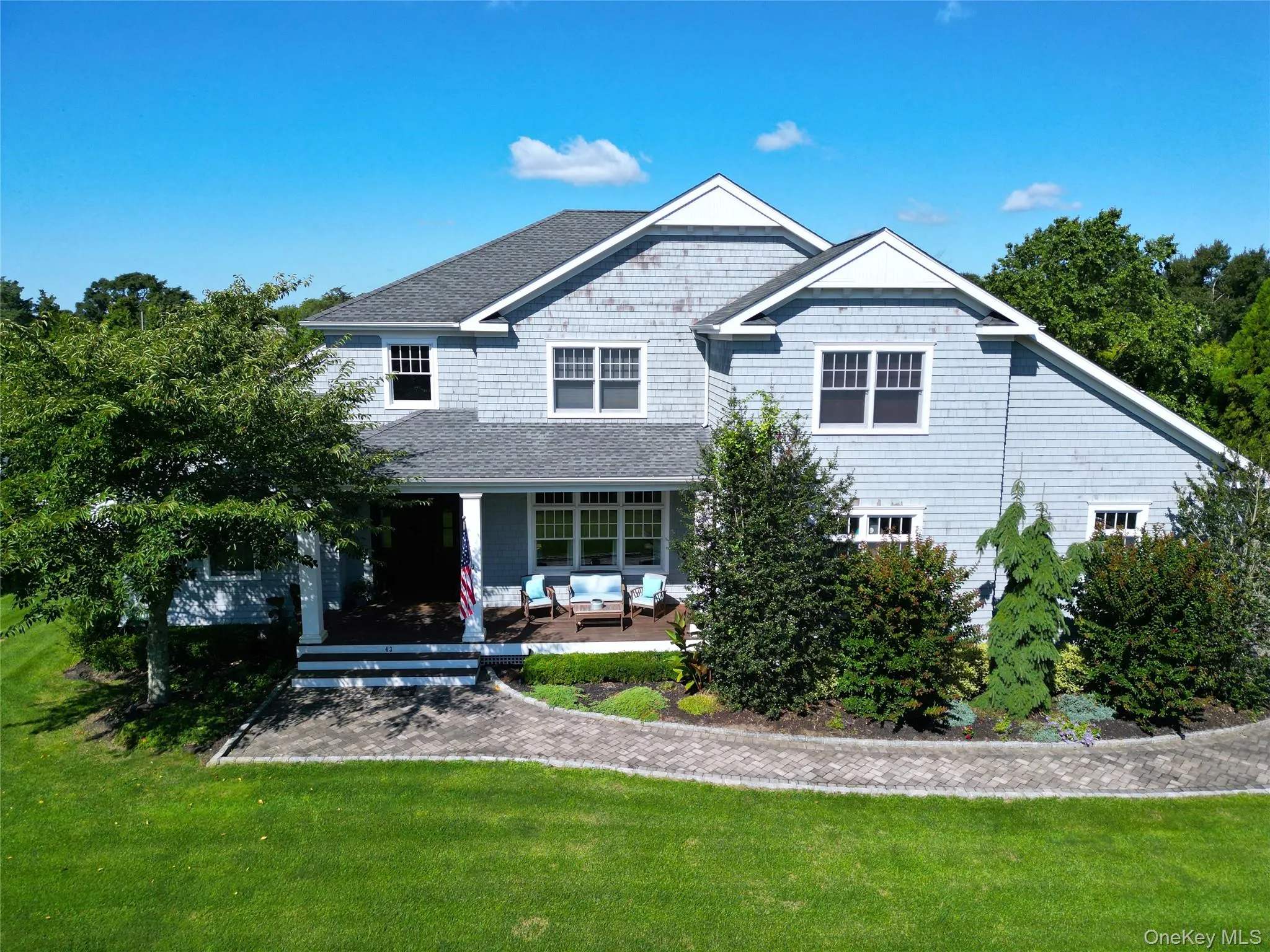 Rear view of property featuring a lawn, an outdoor hangout area, a porch, and roof with shingles Rear view of property featuring a lawn, an outdoor hangout area, a porch, and roof with shingles