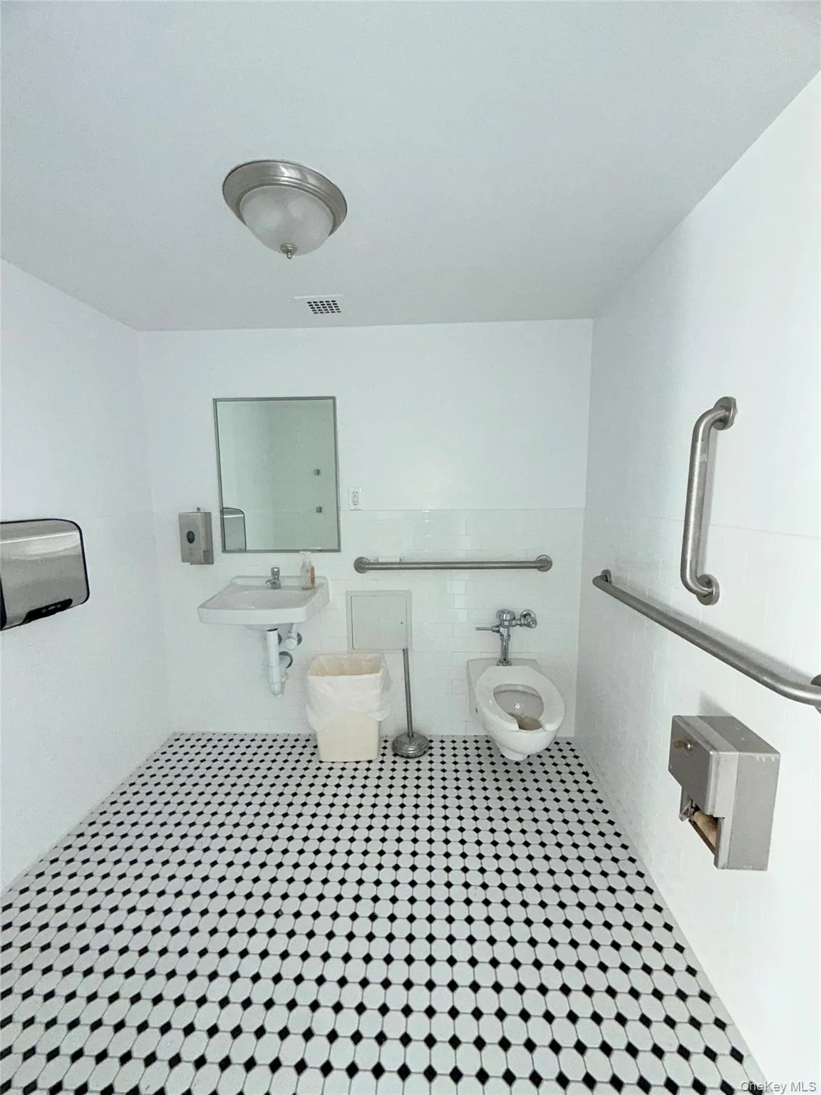 Half bath featuring tile walls and tile patterned flooring Half bath featuring tile walls and tile patterned flooring