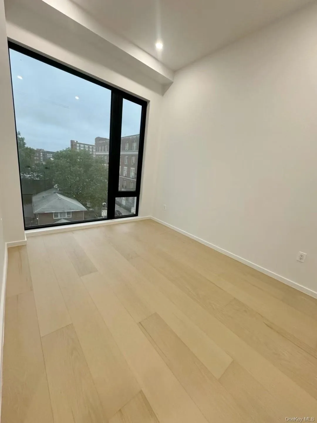 Unfurnished room with wood finished floors and recessed lighting Unfurnished room with wood finished floors and recessed lighting