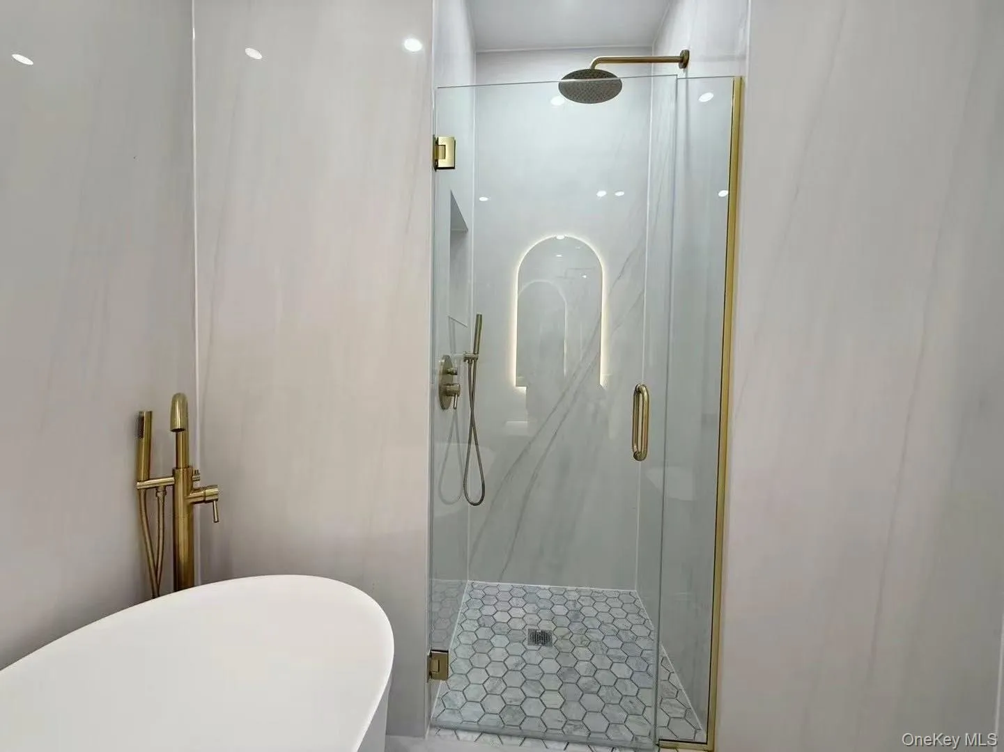 Full bathroom featuring a marble finish shower and a soaking tub Full bathroom featuring a marble finish shower and a soaking tub