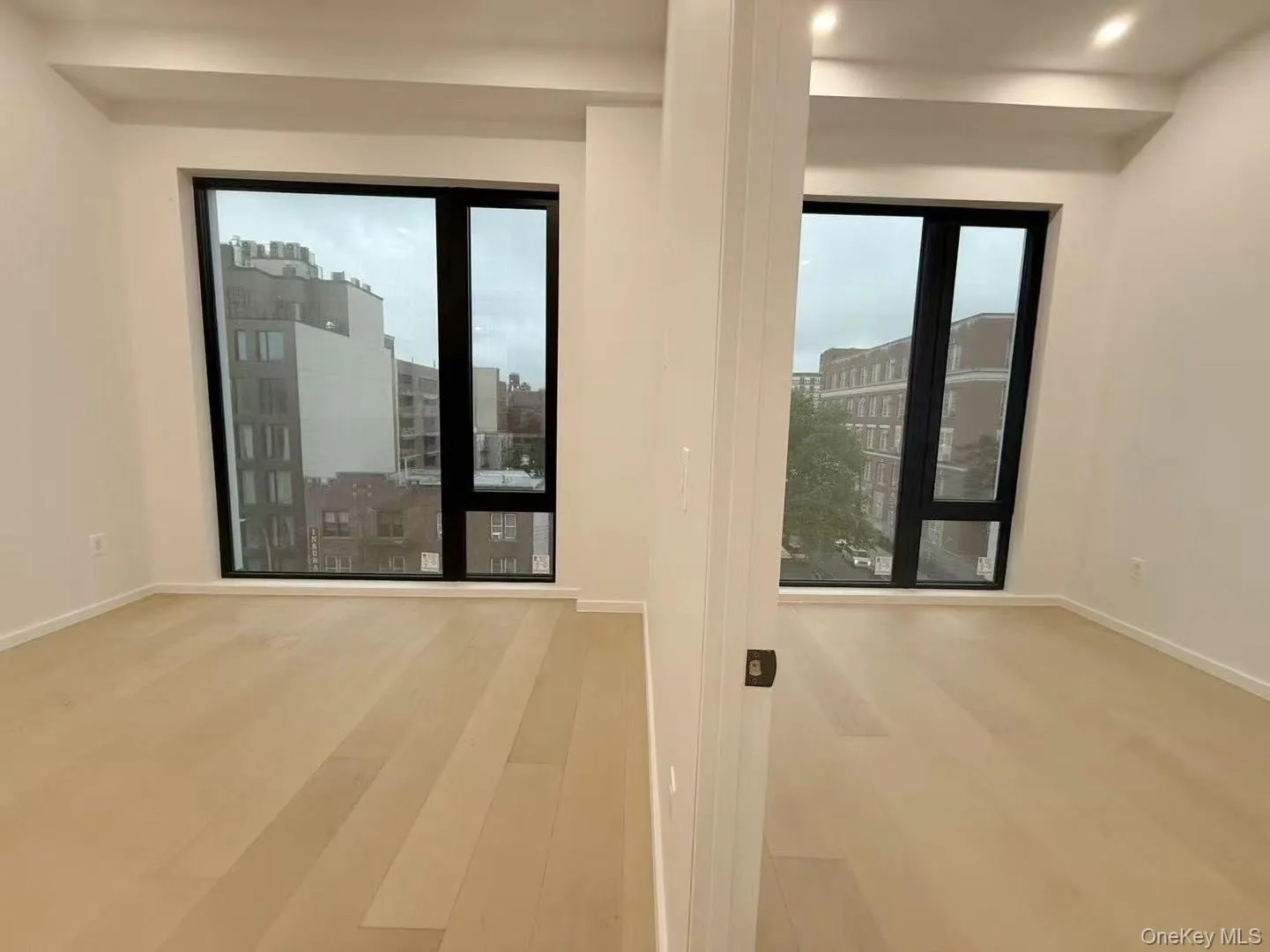 Unfurnished room with wood finished floors and recessed lighting Unfurnished room with wood finished floors and recessed lighting