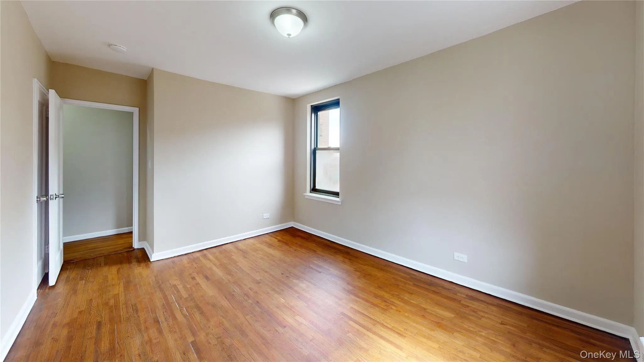 Unfurnished room featuring baseboards and light wood finished floors Unfurnished room featuring baseboards and light wood finished floors
