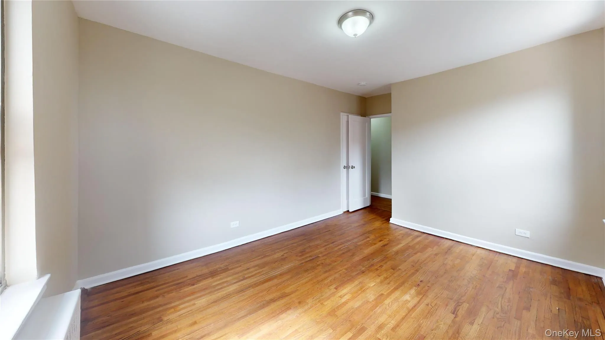 Unfurnished room featuring light wood-type flooring and baseboards Unfurnished room featuring light wood-type flooring and baseboards
