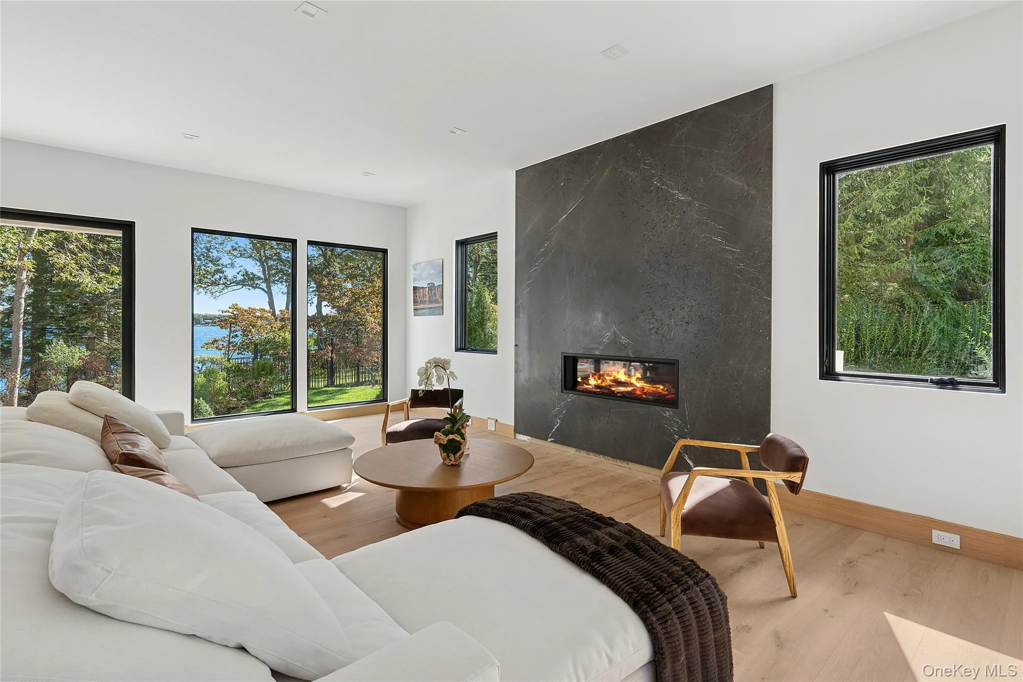 Living room with wood finished floors and a premium fireplace