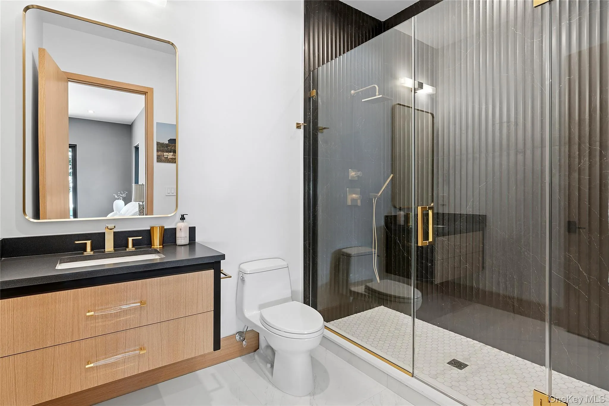 Bathroom featuring vanity, a stall shower, and light tile patterned floors Bathroom featuring vanity, a stall shower, and light tile patterned floors