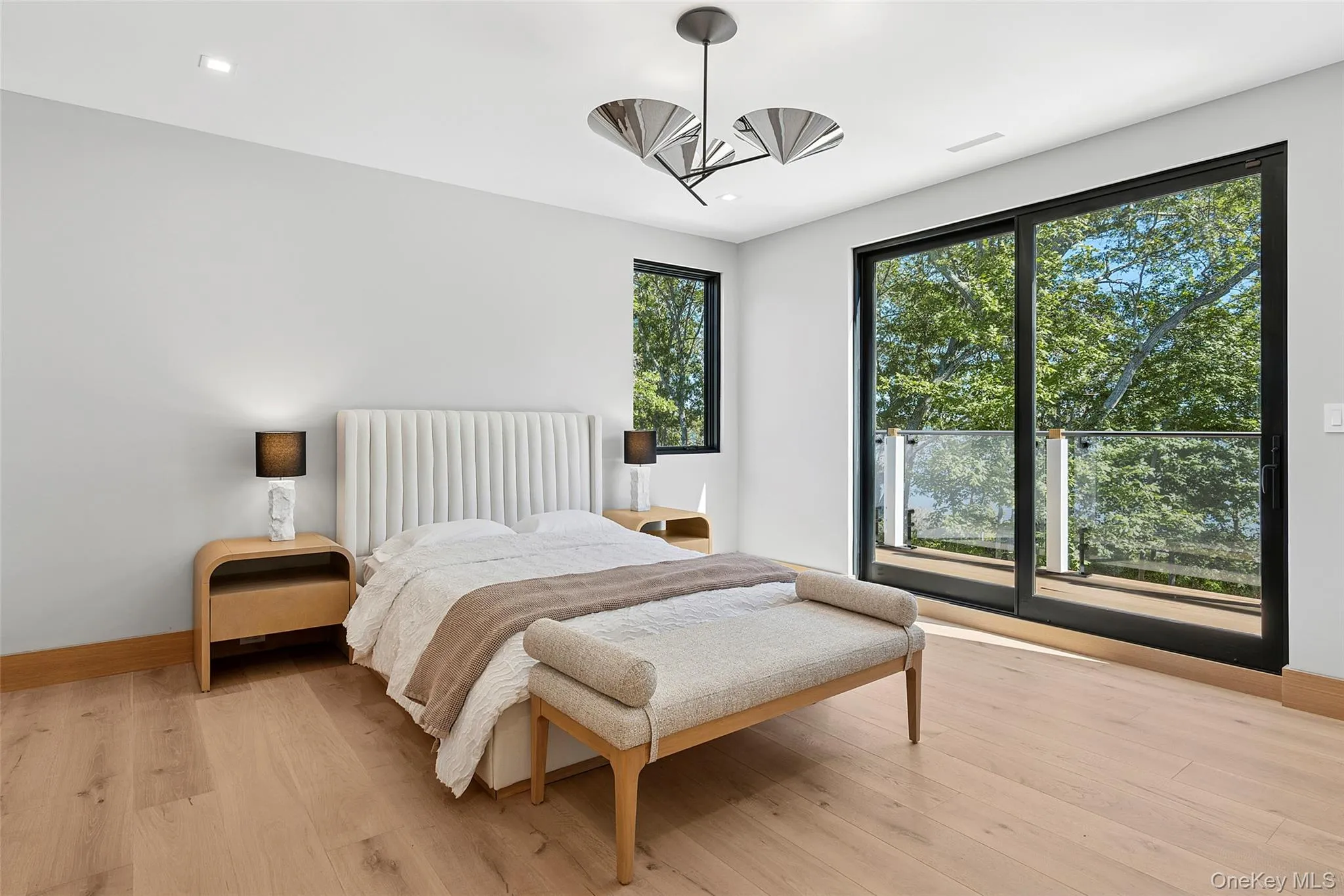 Bedroom featuring light wood finished floors and baseboards Bedroom featuring light wood finished floors and baseboards