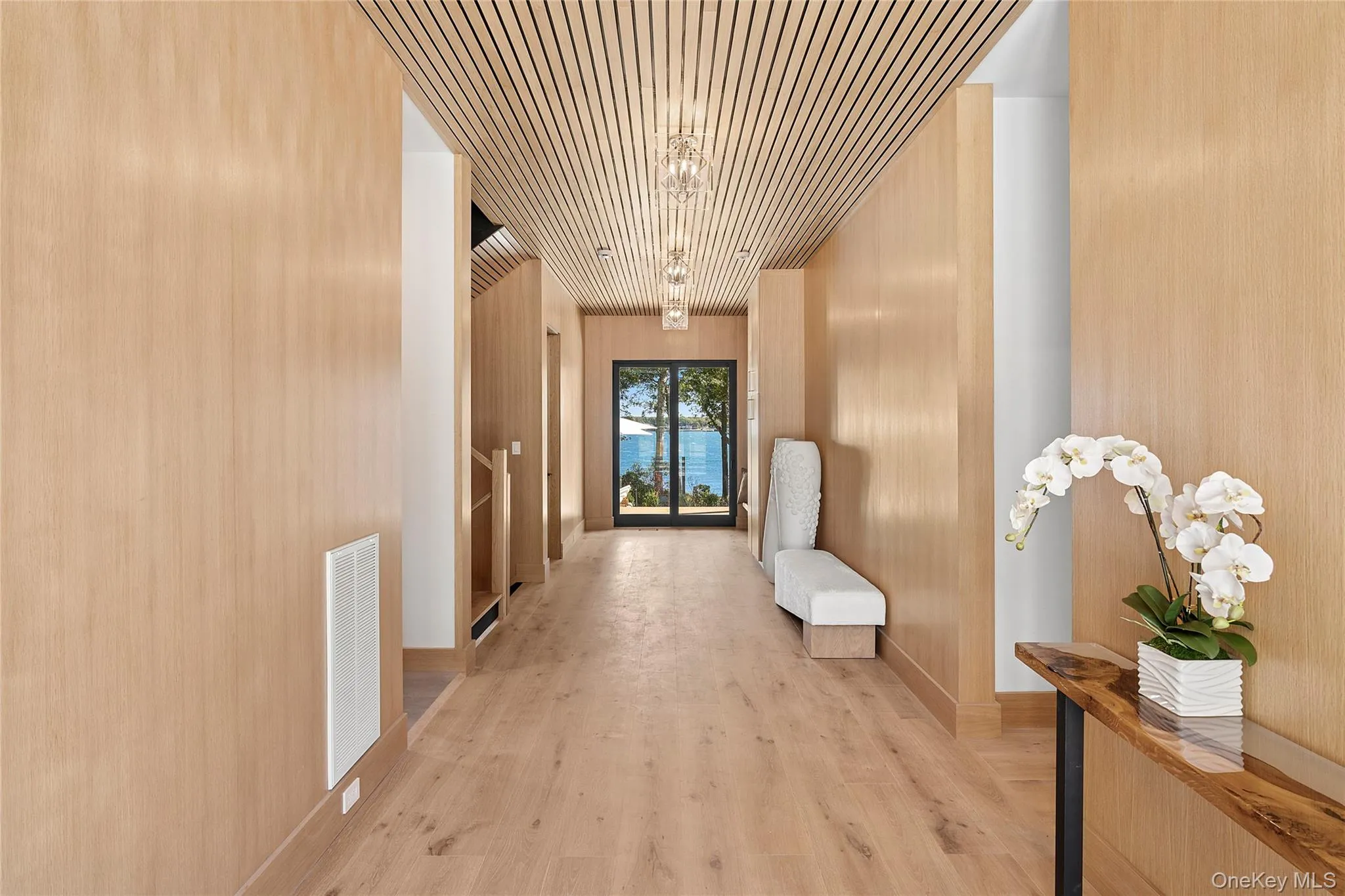 Hallway with light wood-style floors and stairs Hallway with light wood-style floors and stairs