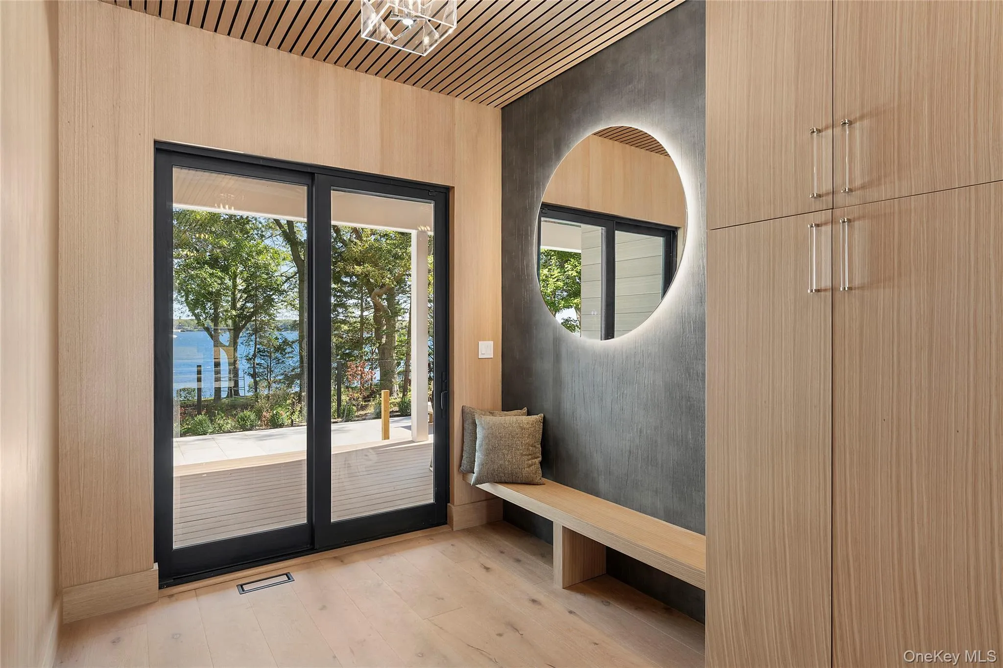 Entryway featuring wood finished floors, plenty of natural light, wood ceiling, and a water view Entryway featuring wood finished floors, plenty of natural light, wood ceiling, and a water view