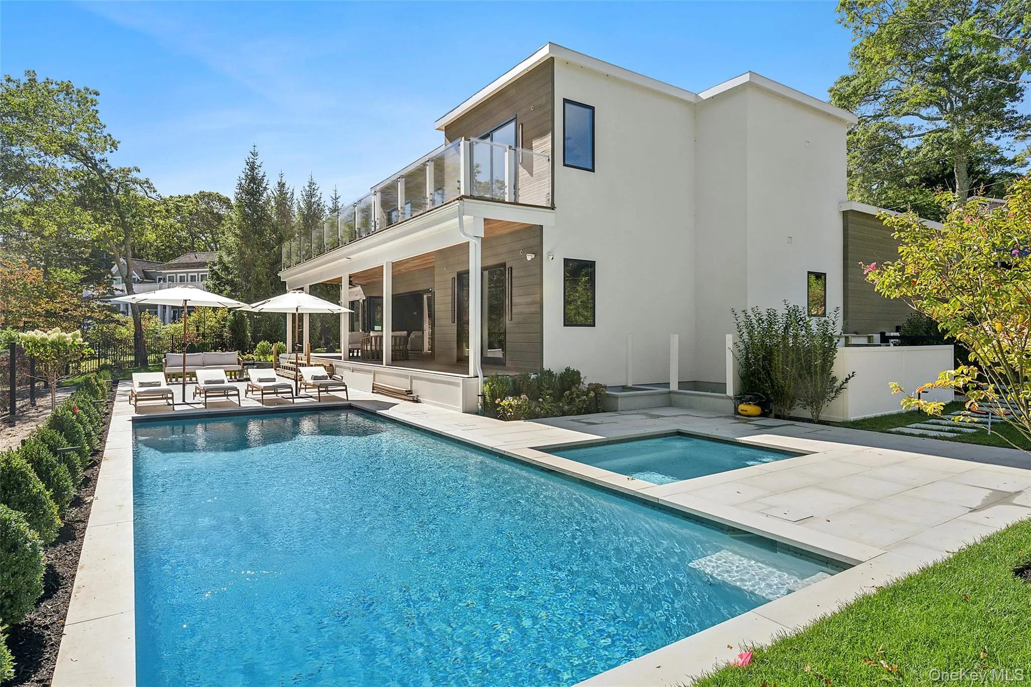 Rear view of property featuring a sunroom, an outdoor pool, an outdoor living space, and a patio Rear view of property featuring a sunroom, an outdoor pool, an outdoor living space, and a patio