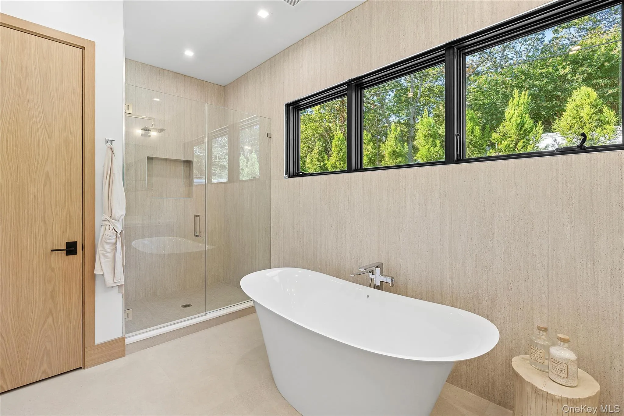 Bathroom featuring a shower stall, a soaking tub, recessed lighting, and wallpapered walls Bathroom featuring a shower stall, a soaking tub, recessed lighting, and wallpapered walls