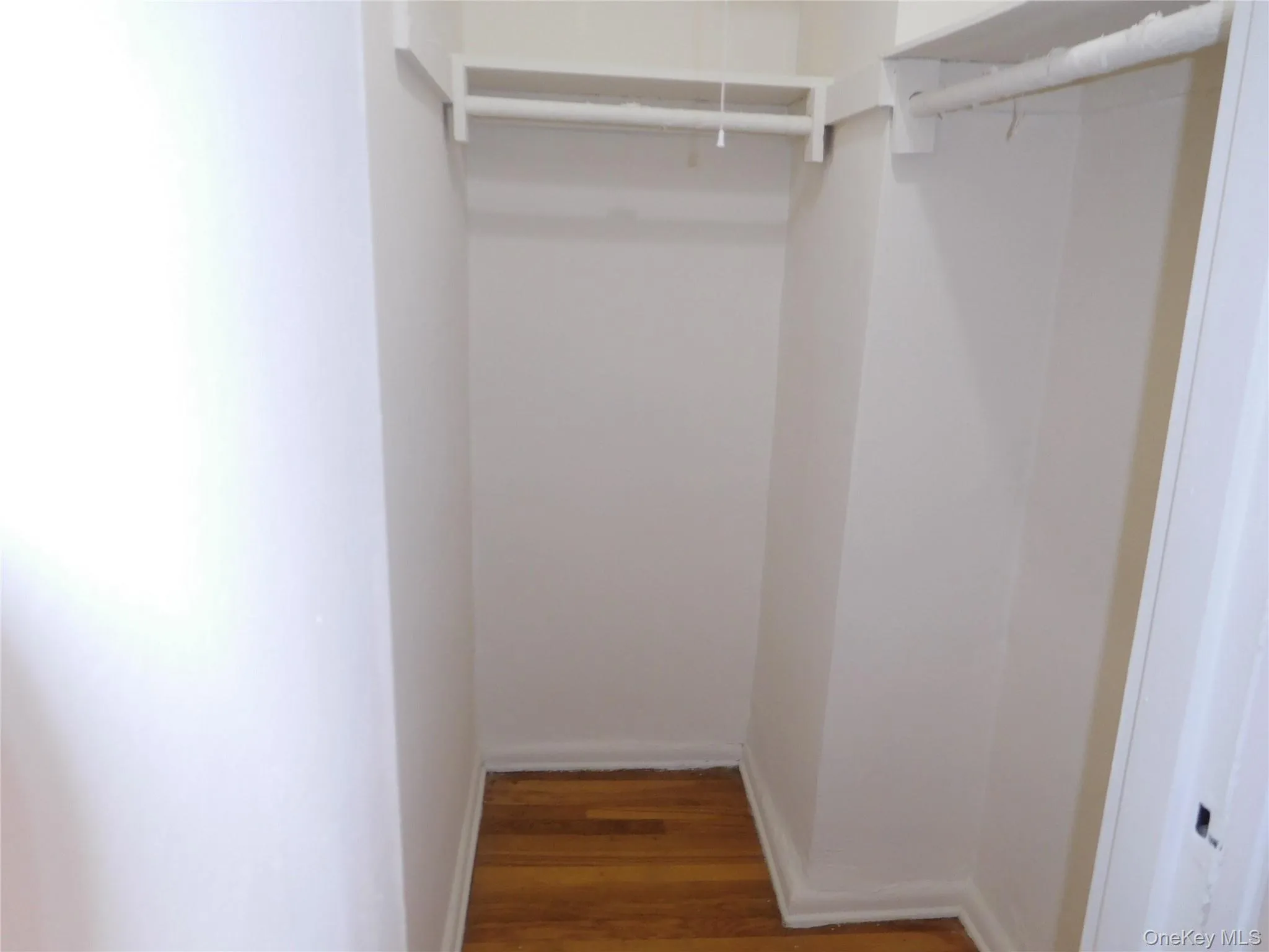 Spacious closet featuring light wood-style flooring Spacious closet featuring light wood-style flooring