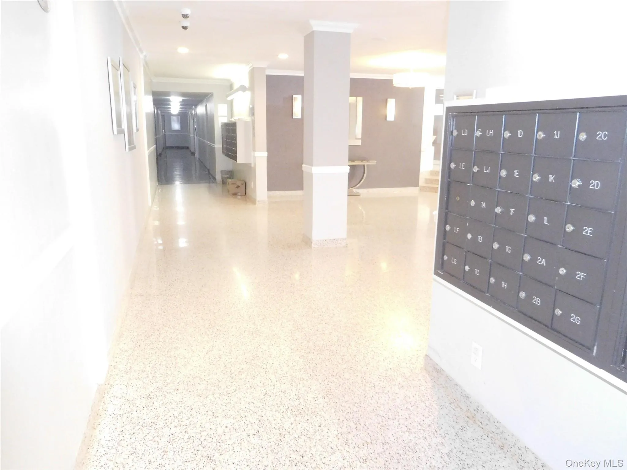 Corridor with dark aggregate flooring and recessed lighting Corridor with dark aggregate flooring and recessed lighting