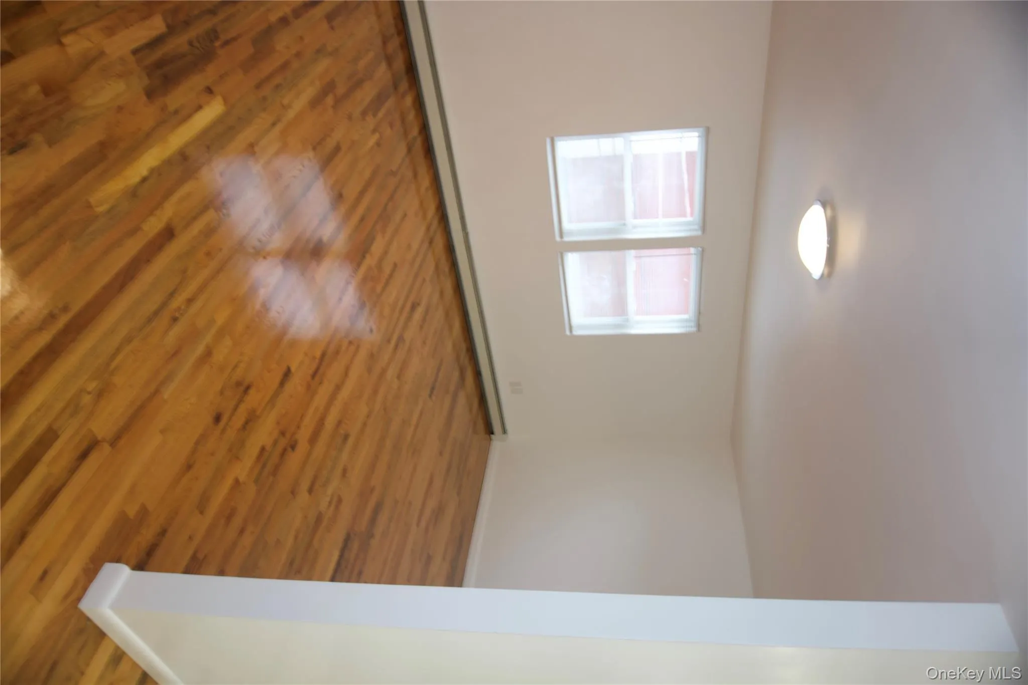 Spare room featuring baseboard heating and light wood finished floors Spare room featuring baseboard heating and light wood finished floors