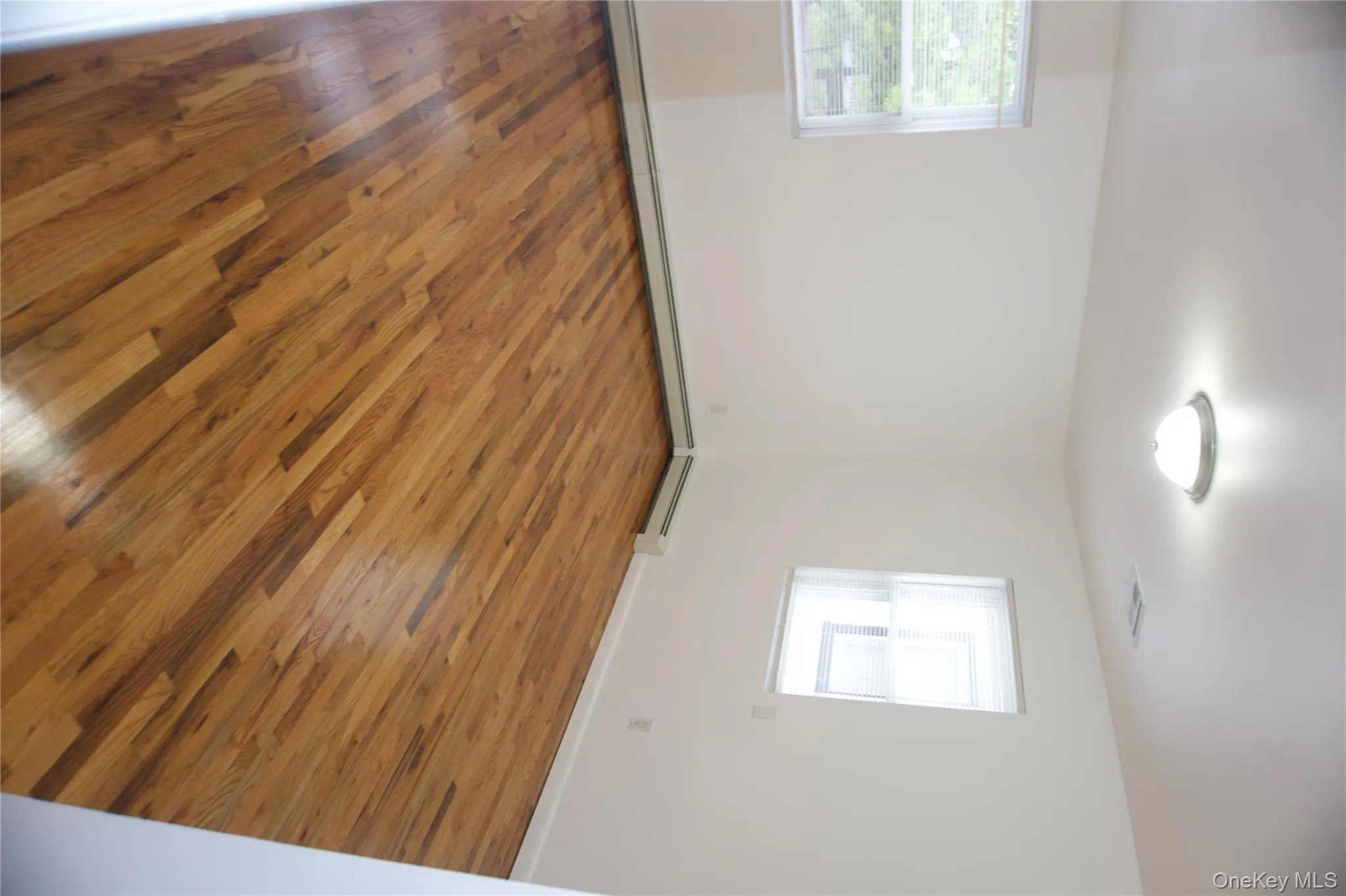 Spare room featuring wood finished floors Spare room featuring wood finished floors