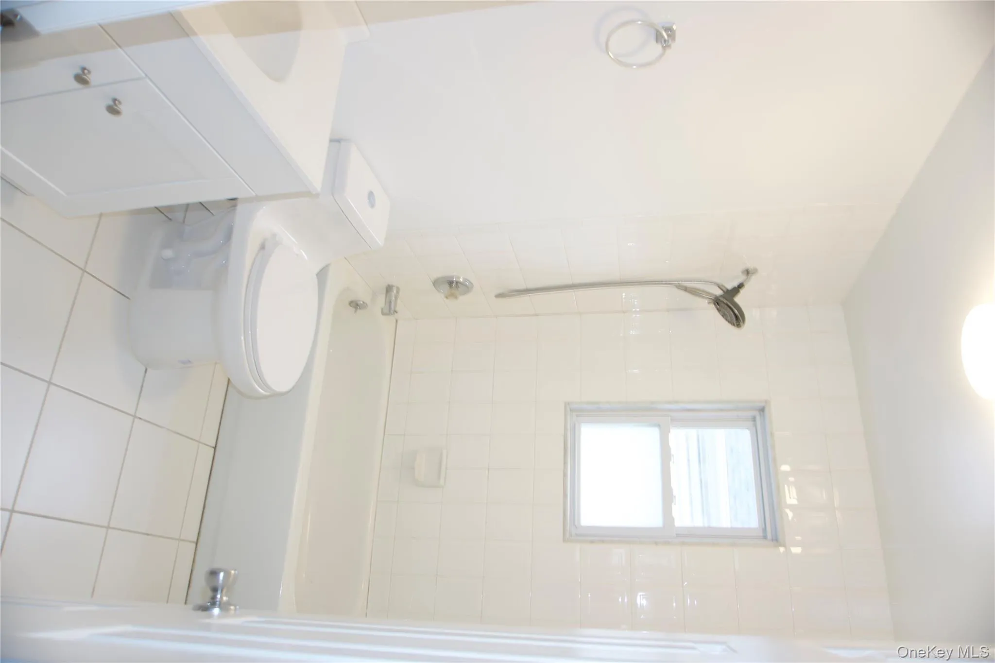 Bathroom featuring light tile patterned floors, vanity, and shower / bath combination Bathroom featuring light tile patterned floors, vanity, and shower / bath combination