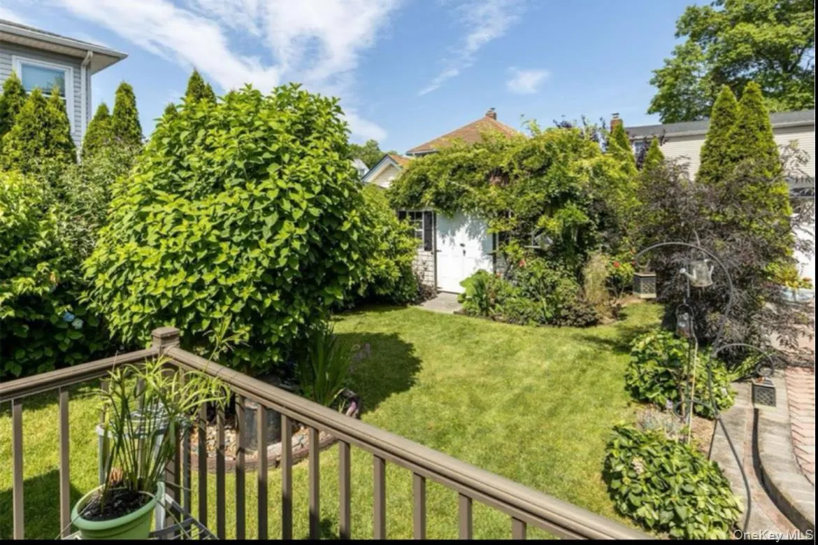View of green lawn with a balcony View of green lawn with a balcony